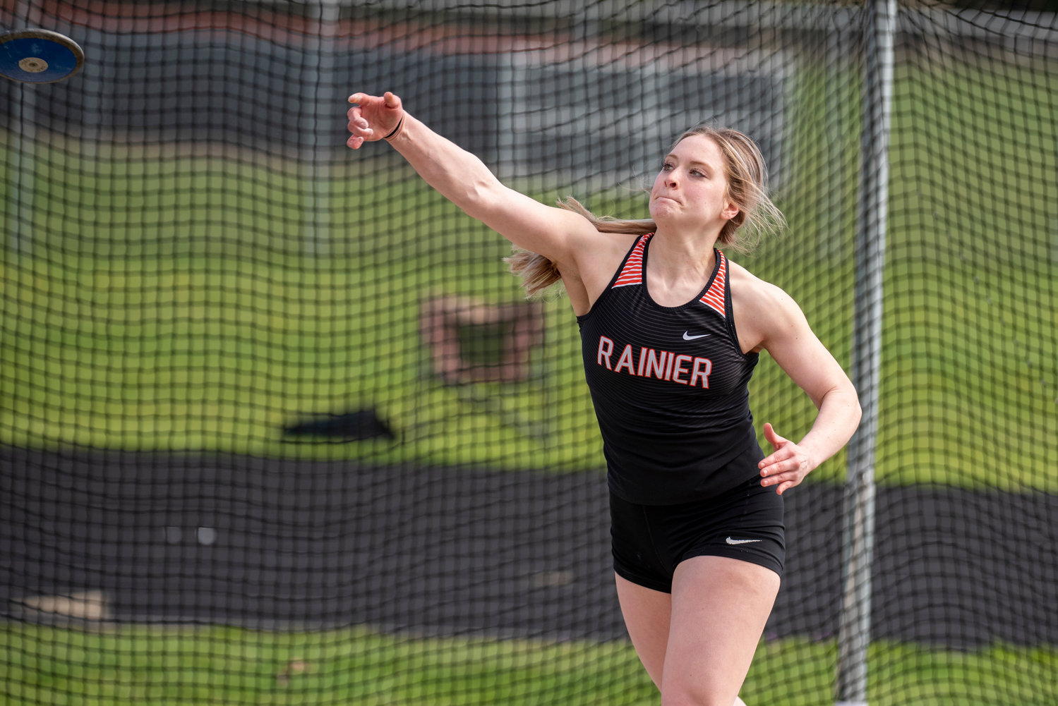 Rainier senior Isabella Holmes unleashes the discus during a track and field meet at Napavine on March 31.