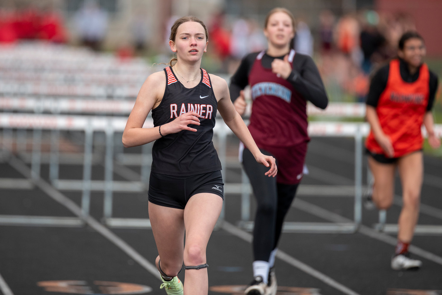 Rainier's Emma Mathson crosses the finish line first in the girls 100-meter hurdles during a track meet in Napavine on March 31.