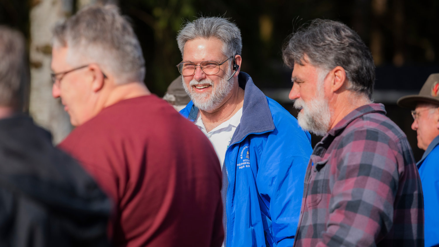 Ed Orcutt smiles as coho are released into Gheer Creek Friday morning in Onalaska.