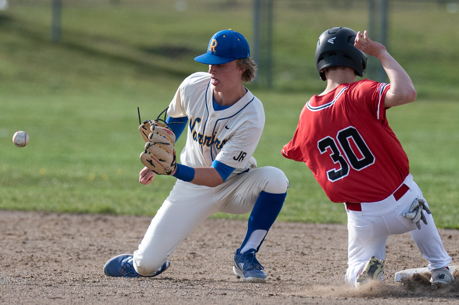 Shelton's Austin Williams reaches base just before the throw from the catcher reaches Rochester's Landon Hawes April 7.