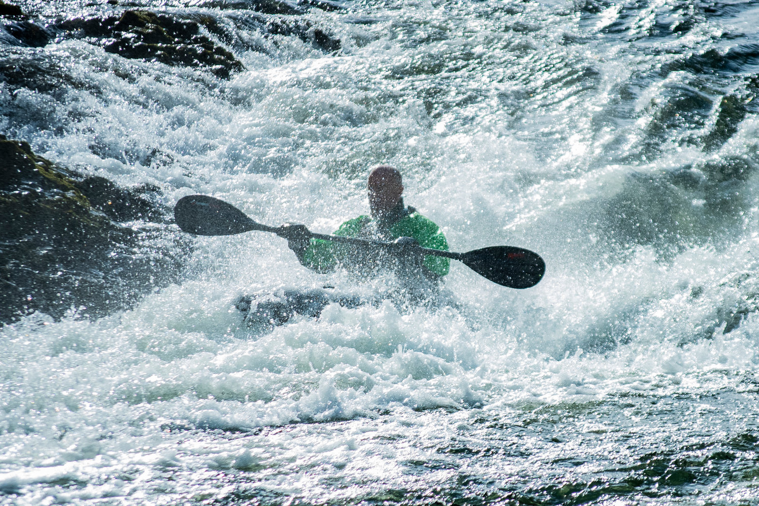 A kayaker rides through the spray at Rainbow Falls during the Pe Ell River Run on Saturday.