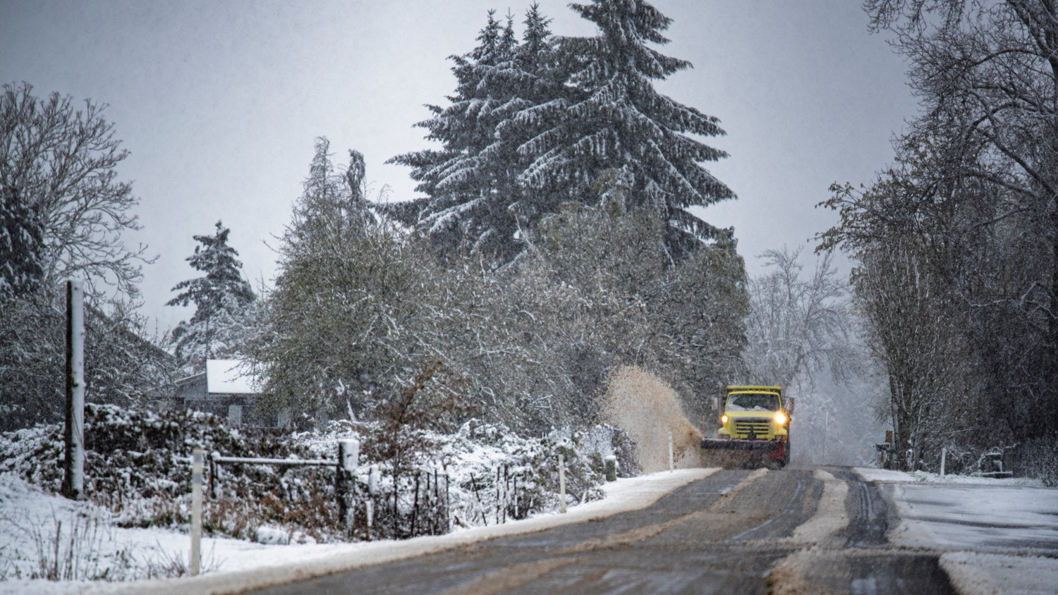 A snow plow travels down Rice Road after moving slush off a portion of the roadway in Chehalis Monday morning.