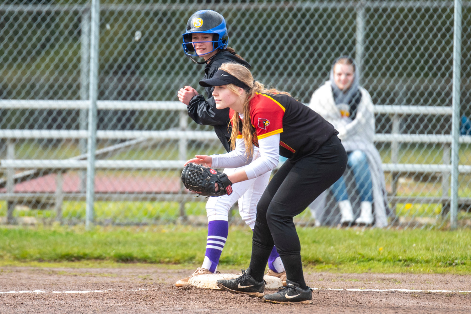 Onalaska's Desi Smith stands on third base while Winlock third baseman awaits the next pitch during a game in Winlock on April 21.