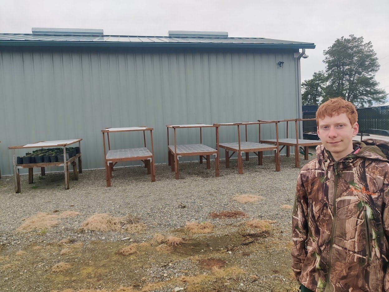 Boy Scout Jesse Ervin poses in front of the tables he’s built as part of his Eagle Scout project for the Scatter Creek Wildlife Area.