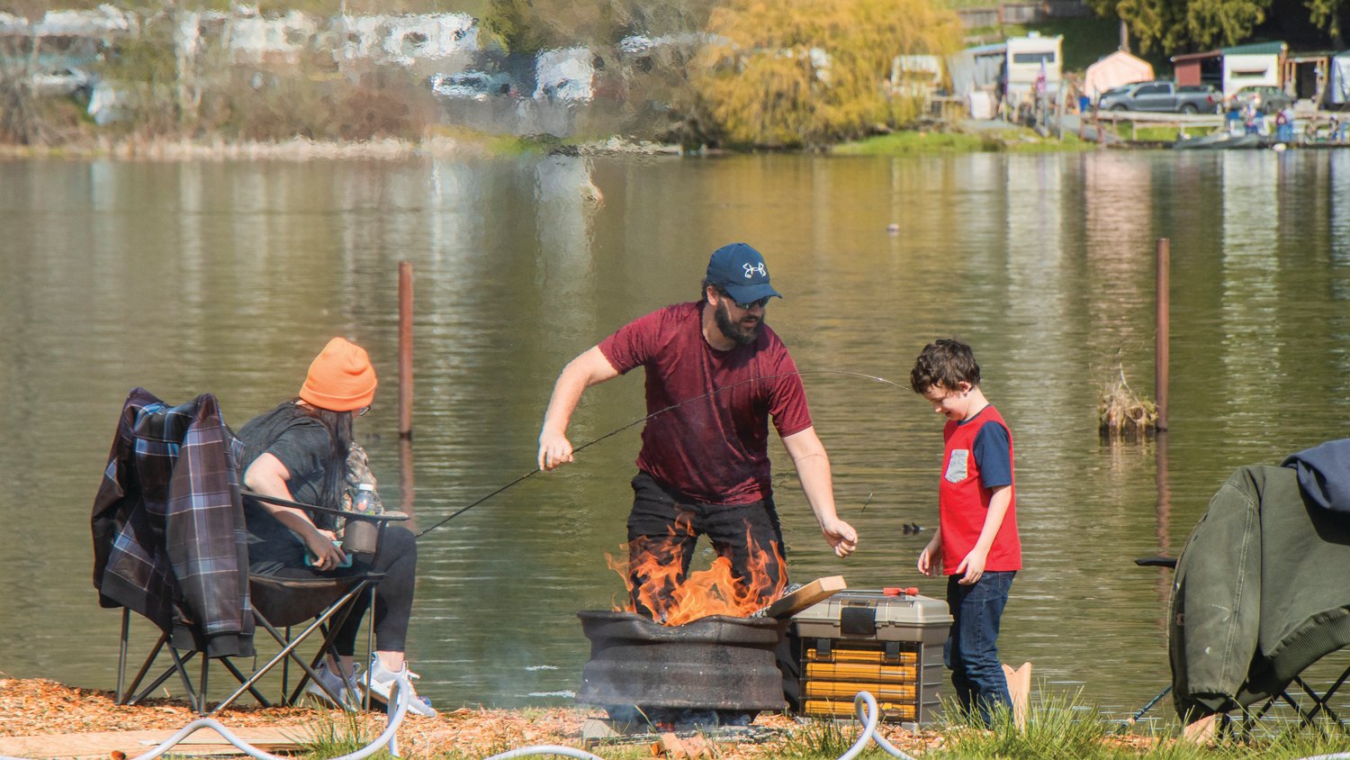 A family camps and fishes near a fire at the Lions Den Campground in Mineral.
