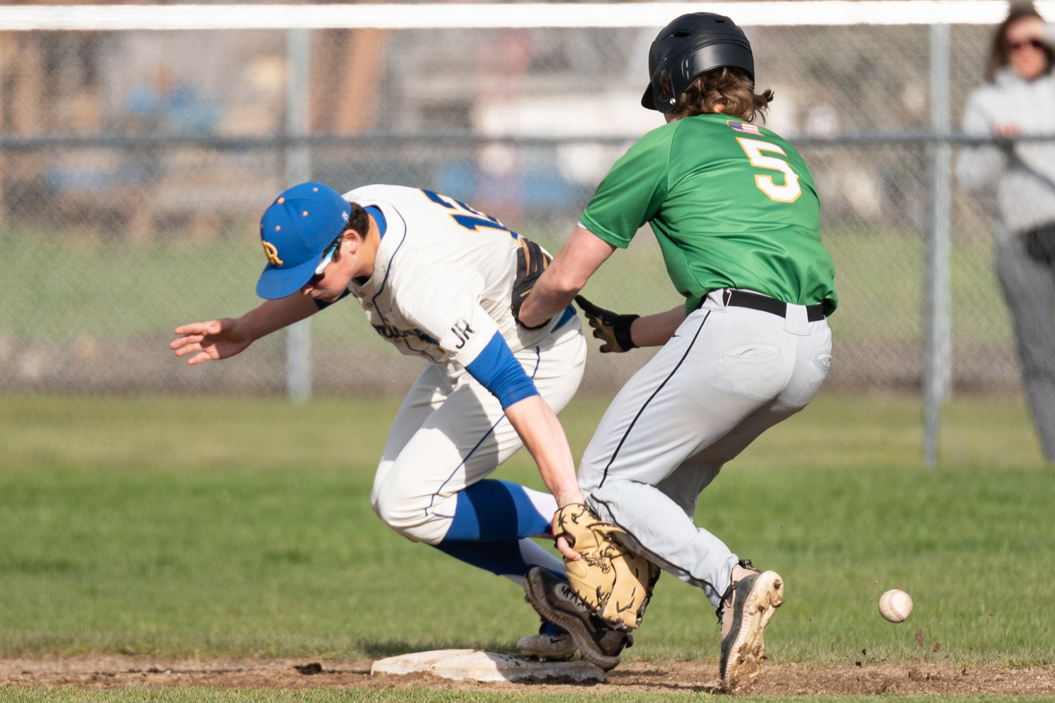 Rochester first baseman Garren Smith is plowed in to by Tumwater's Kyler Collier while trying to handle an errant throw. Collier was ruled safe and drove in two runs on the play.