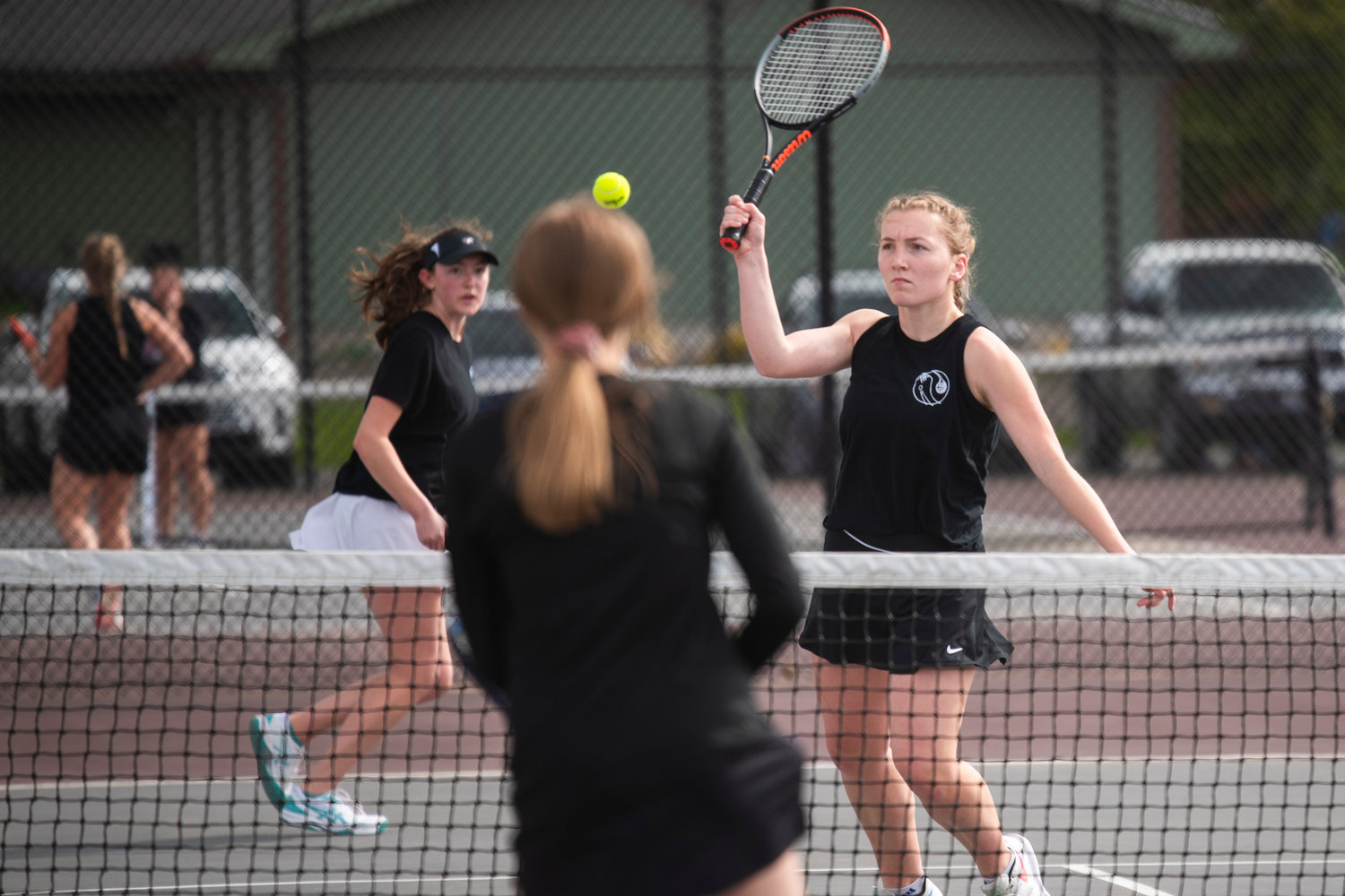 Sophia Stehr, second doubles player for Centralia, hits a volley toward W.F. West’s Emma Hamilton as her partner, Maya O’Dell, watches in Chehalis on Friday.