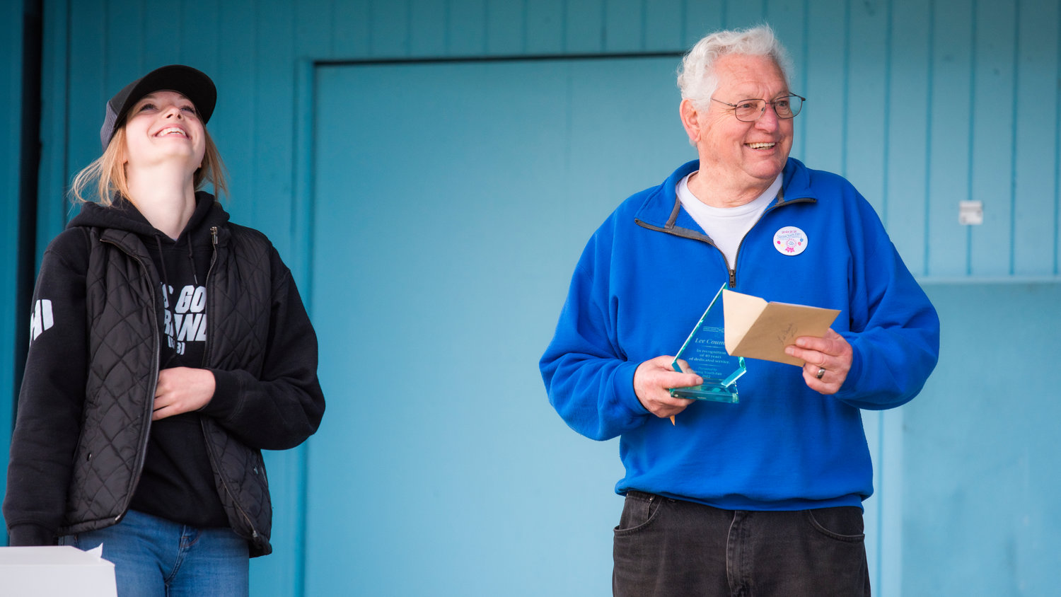 Lee Coumbs reacts as he receives a surprise award for 40 years of service, Sunday during the Spring Youth Fair in Centralia.