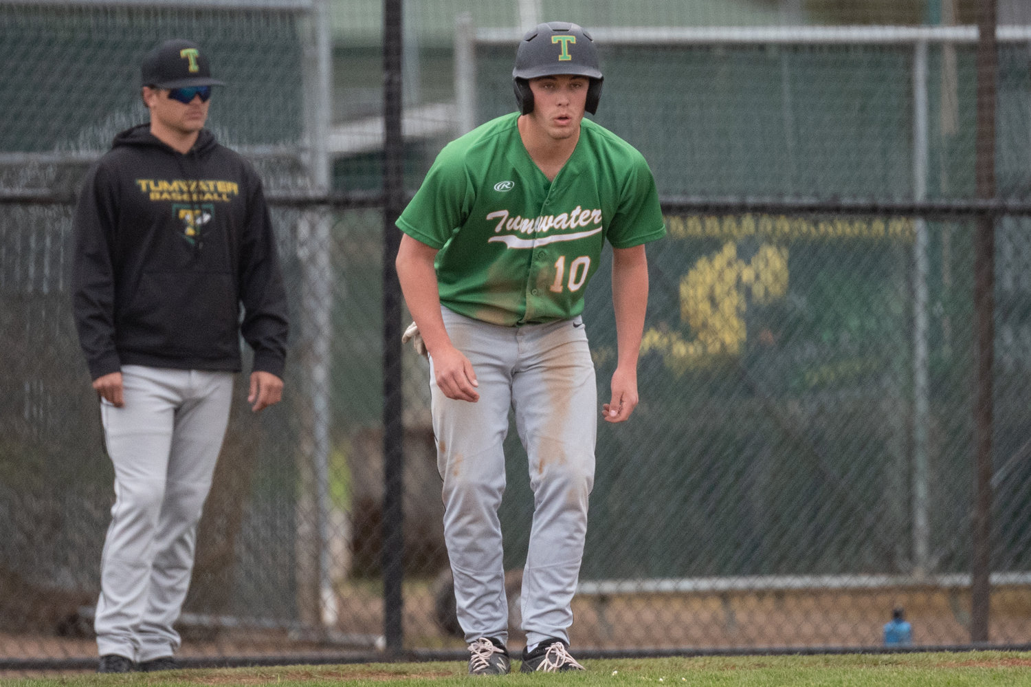 Tumwater's Ryan Orr navigates third base while coach Lyle Overbay looks on against Centralia May 2.