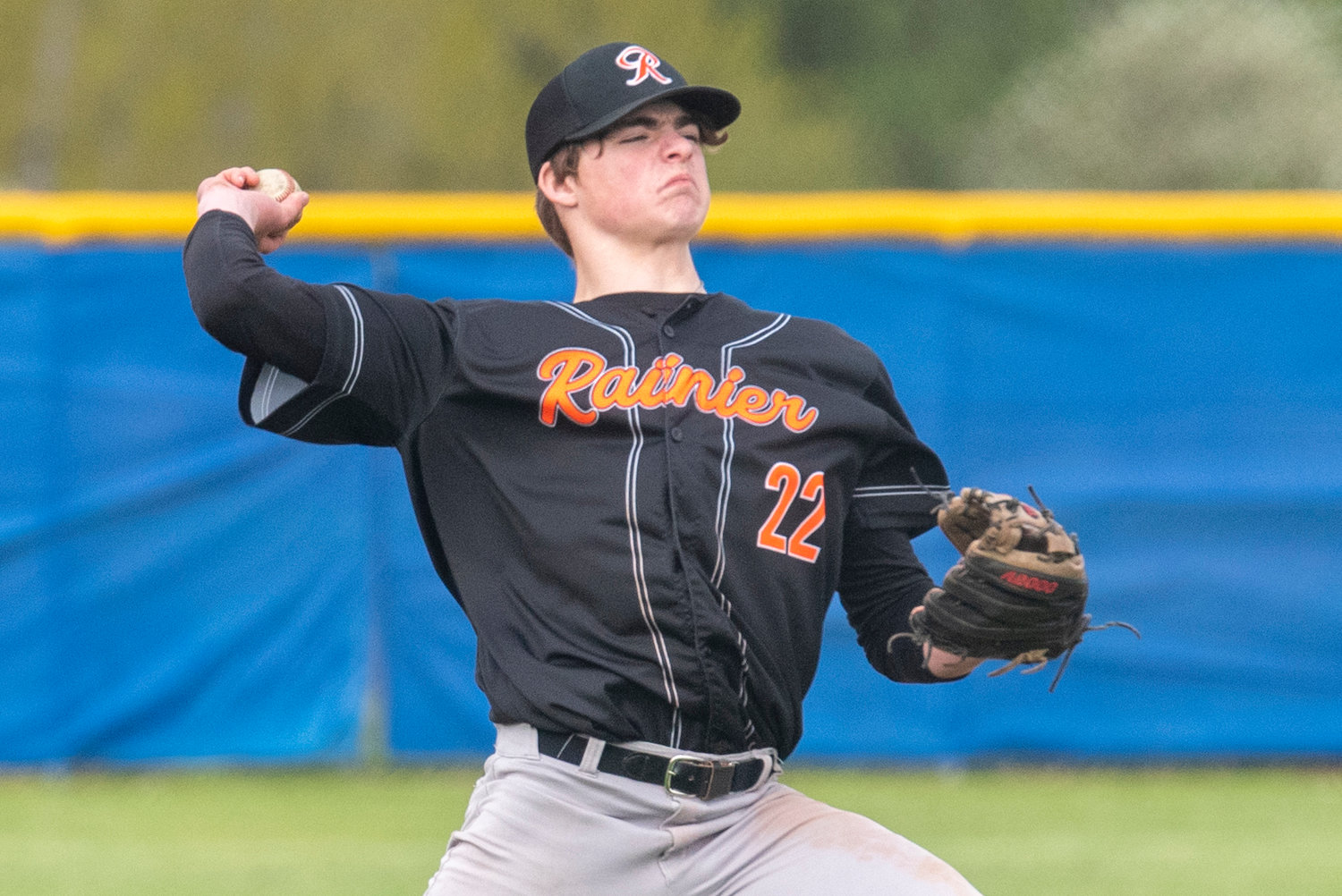 Rainier third baseman Hunter Howell makes a throw to first during a district play-in game on May 3 in Adna.