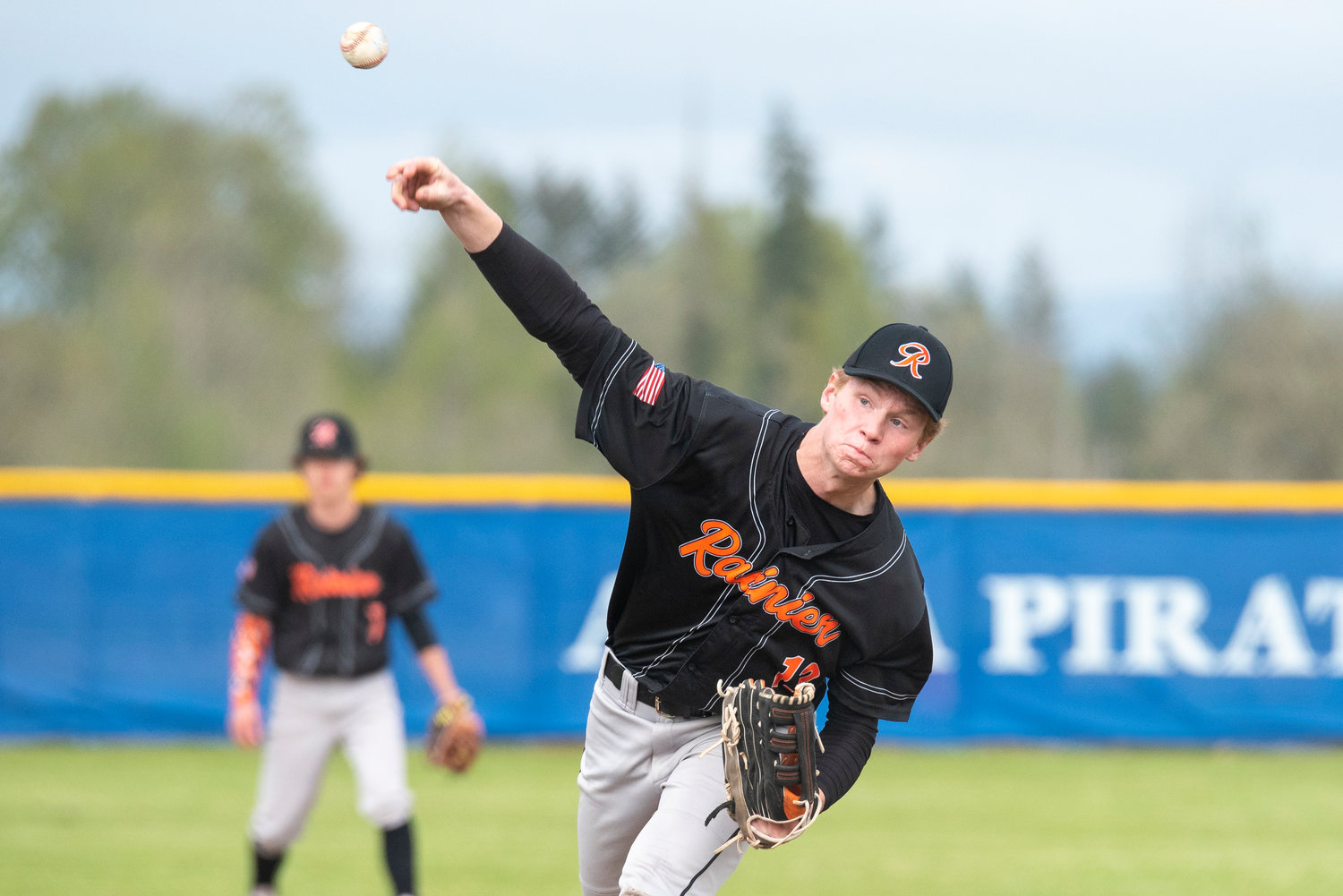 Rainier's John Kenney delivers a pitch to a Wahkiakum batter during a district play-in game at Adna High School on Tuesday, May 3.