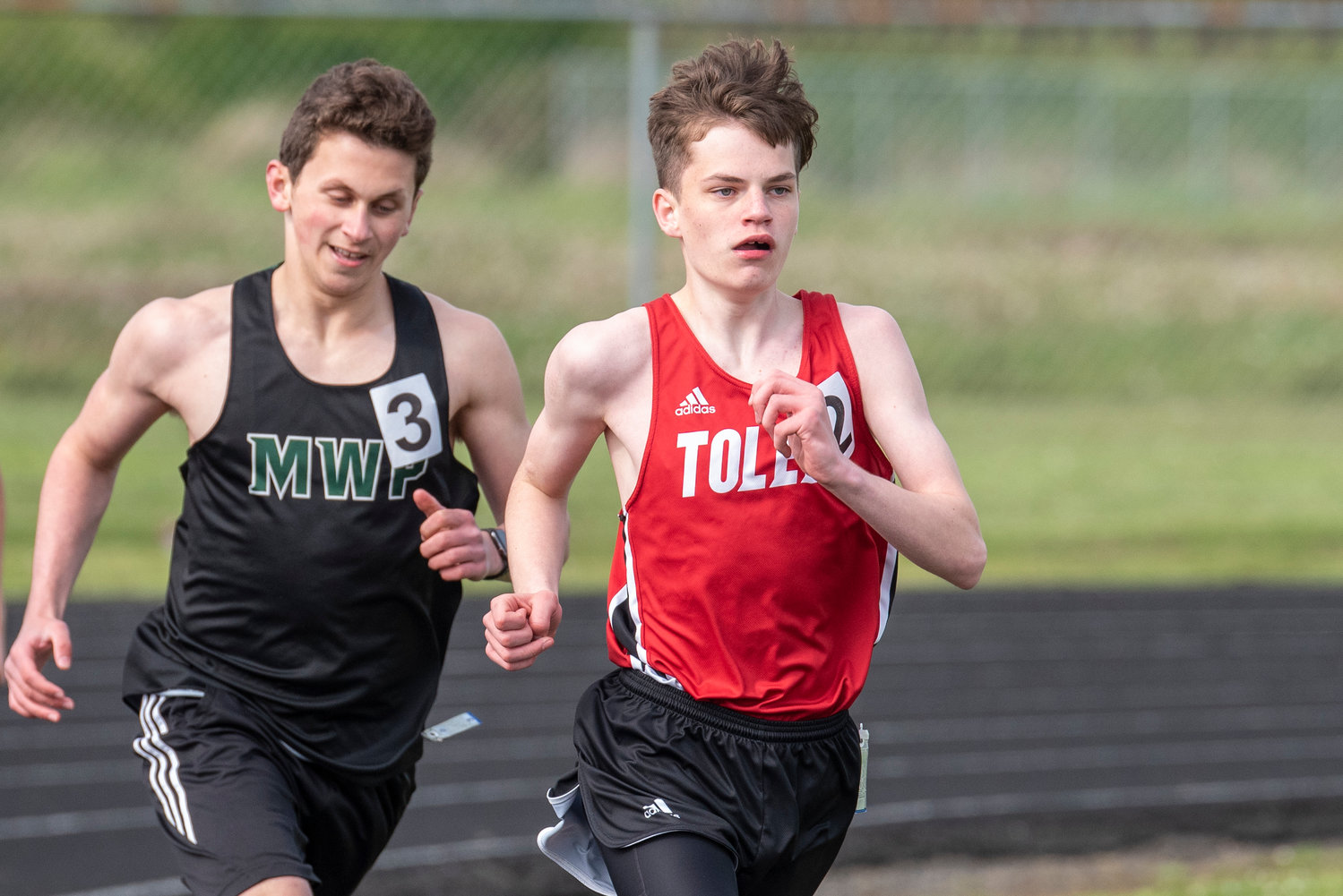 Toledo's Treyton Marty, right, leads the pack in the boys 1600-meter run at the Pirate Classic in Adna on Tuesday, May 3.