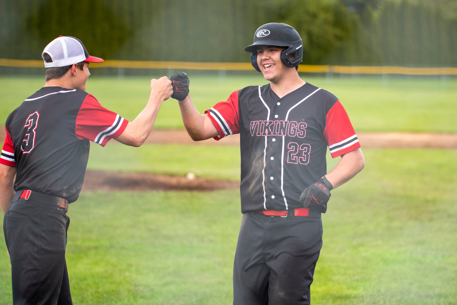Mossyrock's Andrew Bender fist-bumps Easton Kolb after the Vikings defeated Lake Quinault at home on May 9 to advance to the district title game.