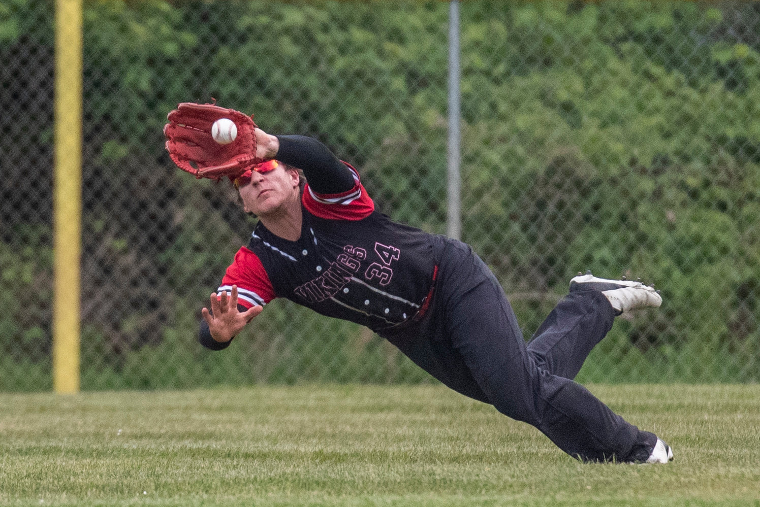 Mossyrock left fielder Marshall Brockway dives for a ball during the district title game against Naselle on May 11.