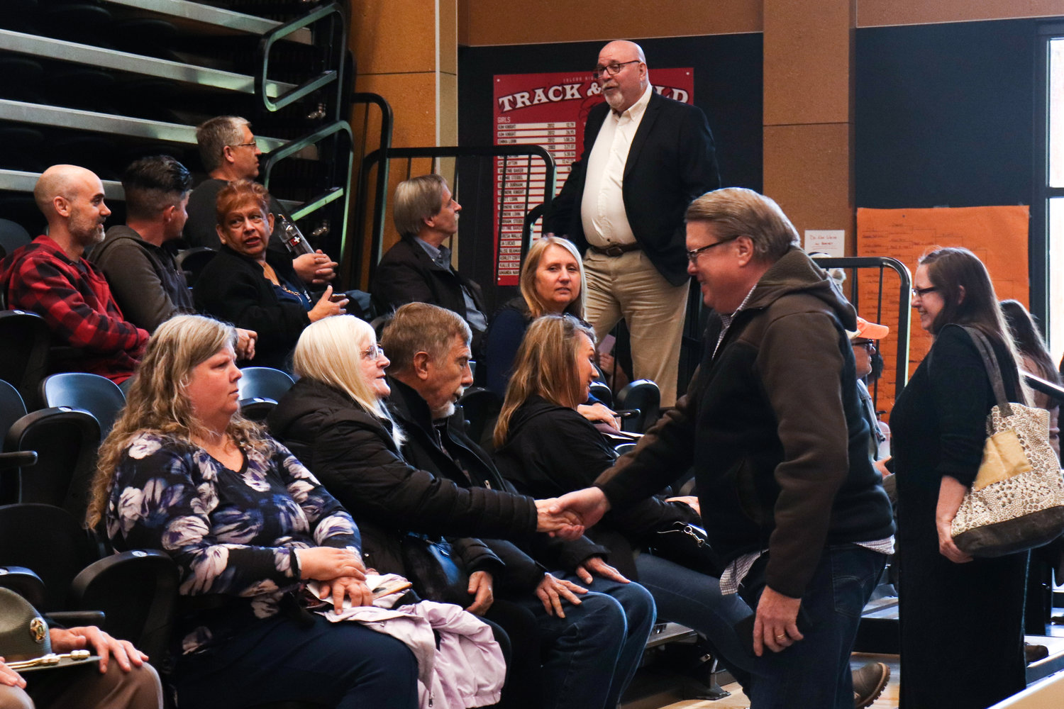 Attendees greet each other before the Big Toledo Community Meeting at Toledo High School on Thursday. The meeting is for residents from the greater Toledo area to gather, share information, project updates, upcoming events and ideas for Toledo.