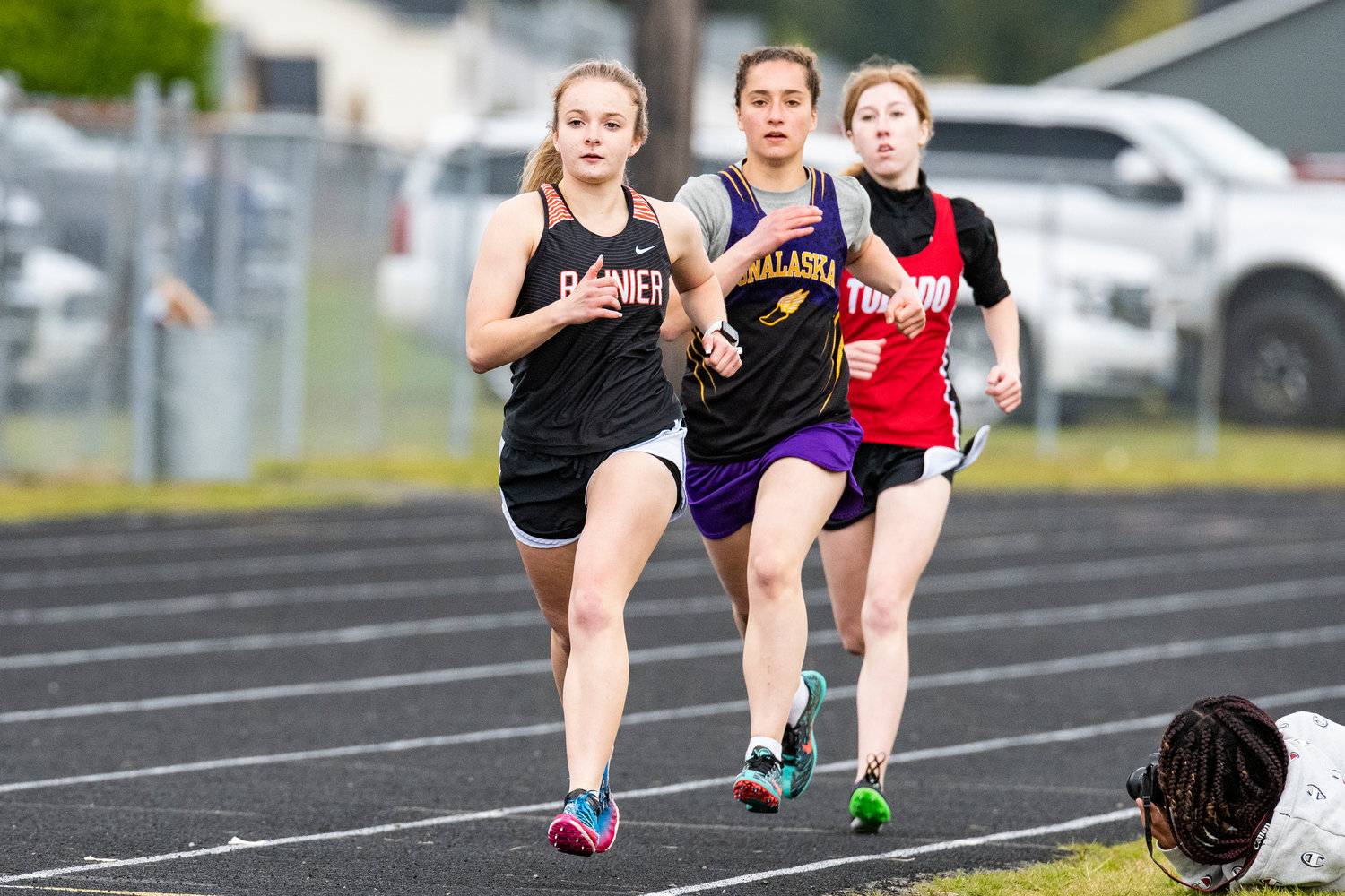 Rainier's Selena Niemi, Onalaska's Melissa Reiman and Toledo's Karley Harris compete in the 1600-meter run at the Central 2B League Championships on May 13.