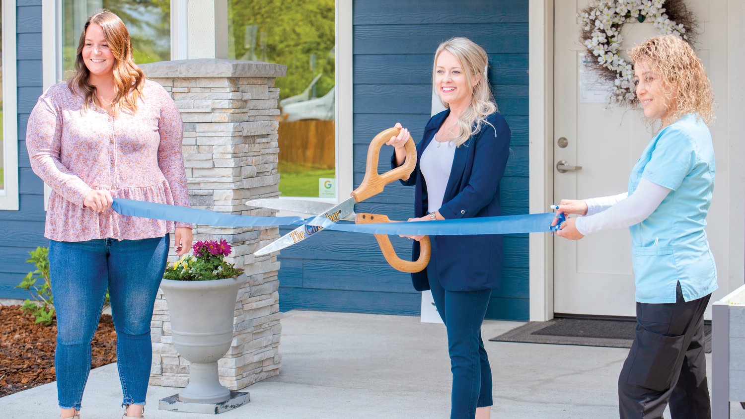 From left, Resident Care Manager Jahnel Otten, Owner RN Danae Elsner and caregiver Rosa Mejia smile and pose during a Centralia-Chehalis Chamber of Commerce Ribbon Cutting event at Silver Acres Adult Family Homes  last Wednesday.