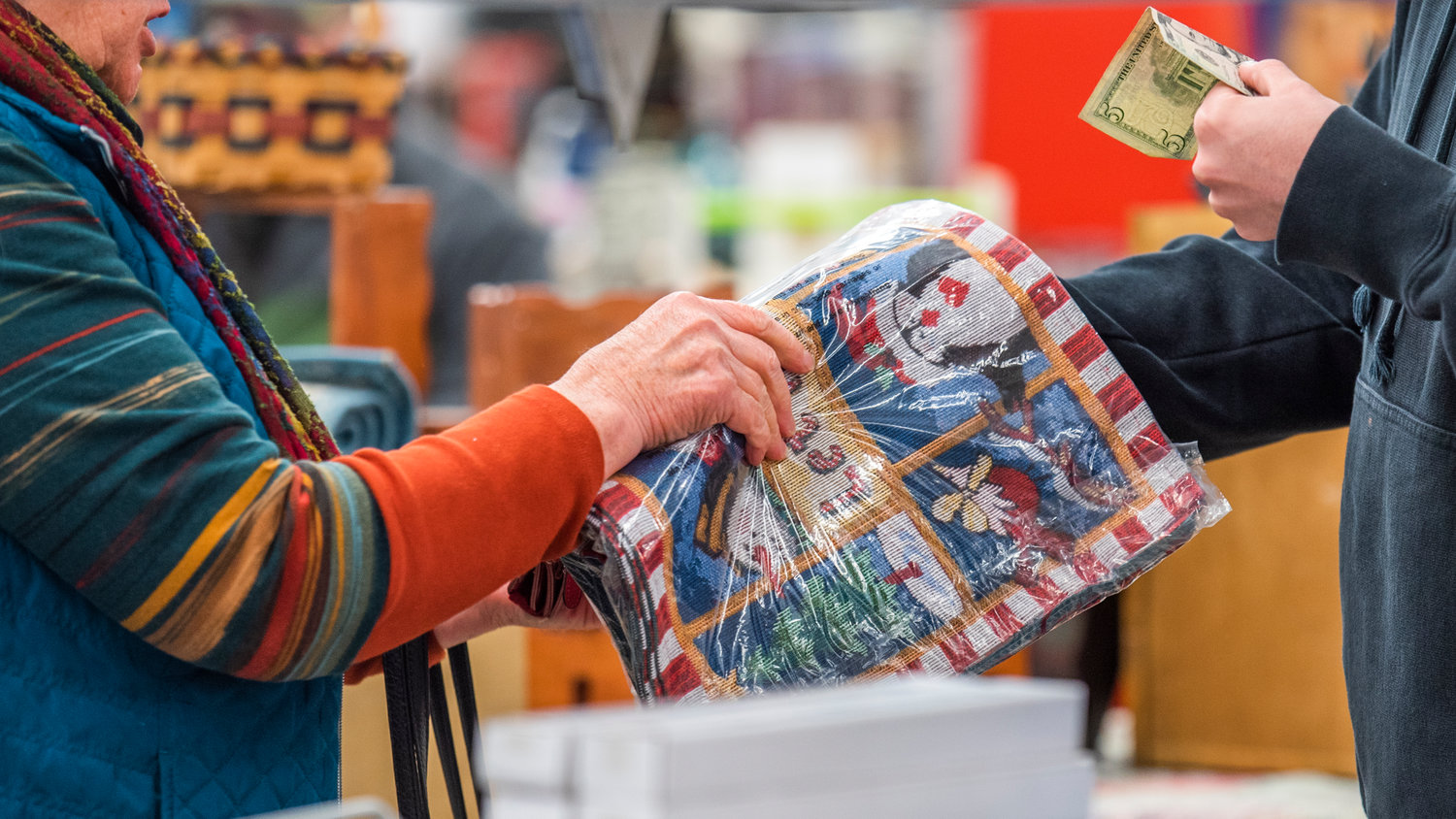 Money is exchanged in the grandstands during the Spring Community Garage Sale Saturday morning at the Southwest Washington Fairgrounds in Centralia.