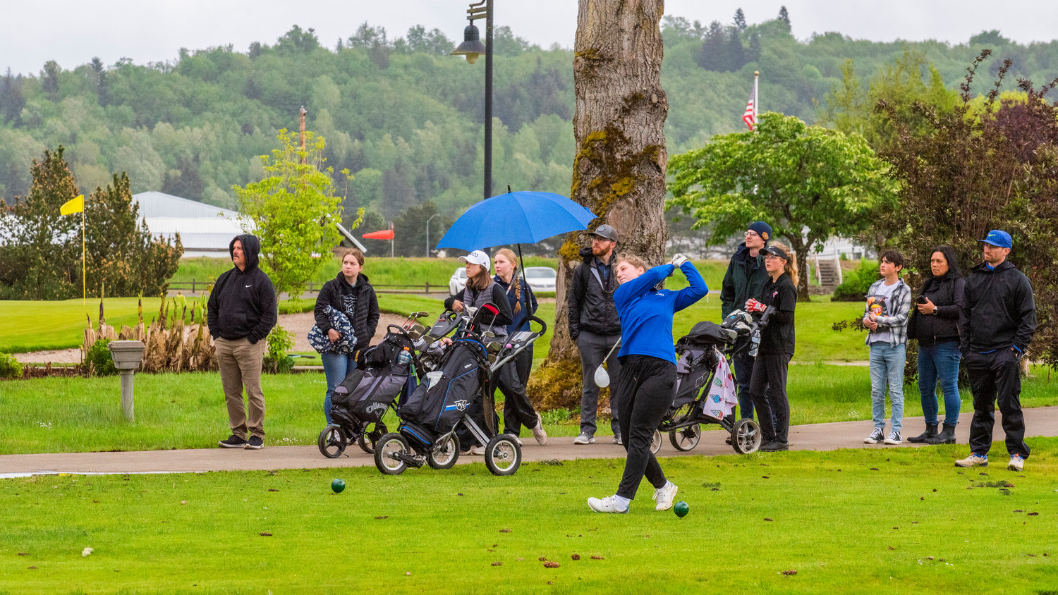 Adna junior Parker Feist tees off for a crowd Wednesday afternooon, on day two of District 2B golf, at Riverside in Chehalis.