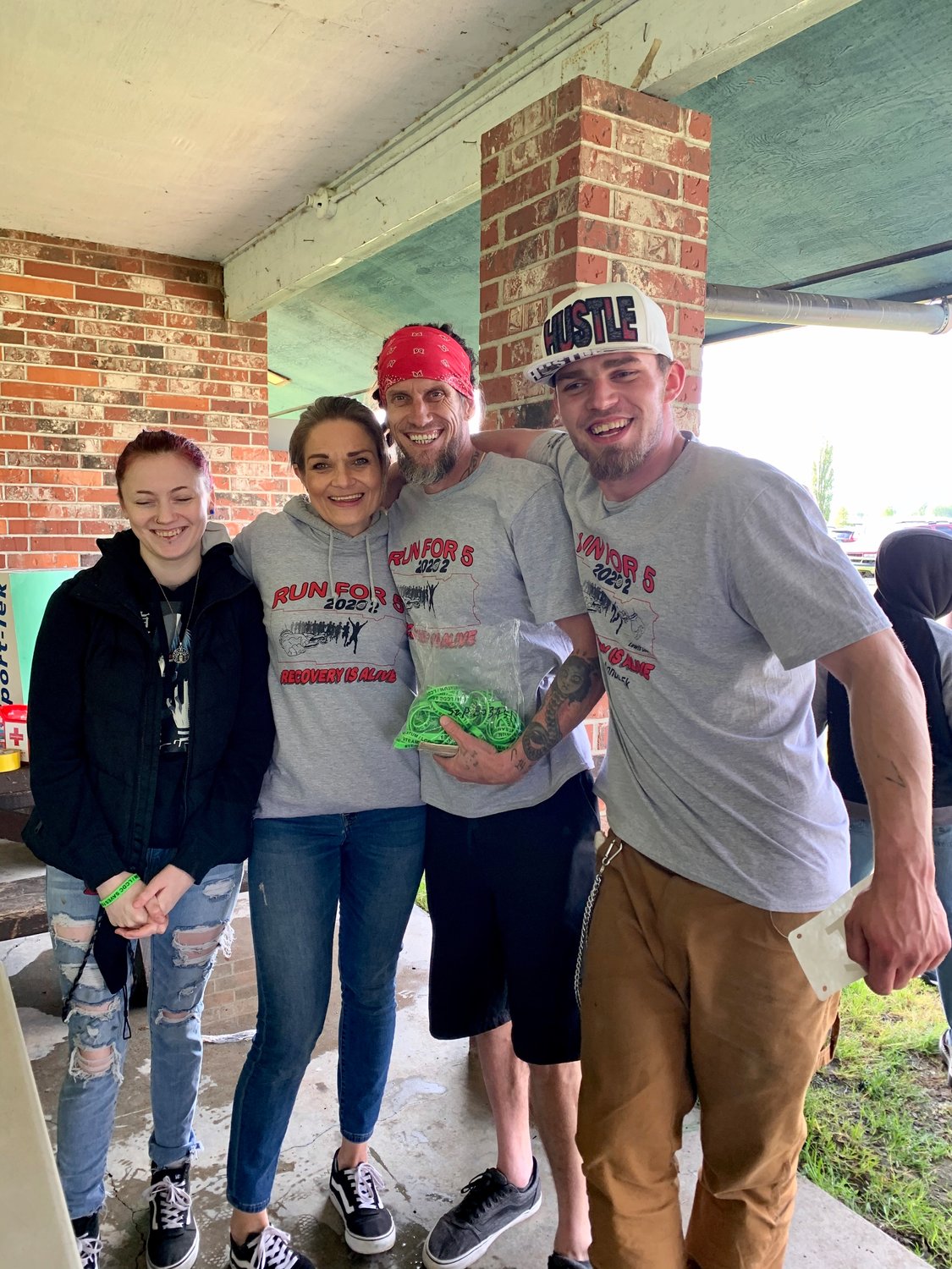 From left, Isabella Westergard, Brooke Reder, Lewis County Drug Court Foundation President Troy Westergard and Austin Carson pose for a photo at the Run for Five, Recovery is Alive 5K in Chehalis on Monday.
