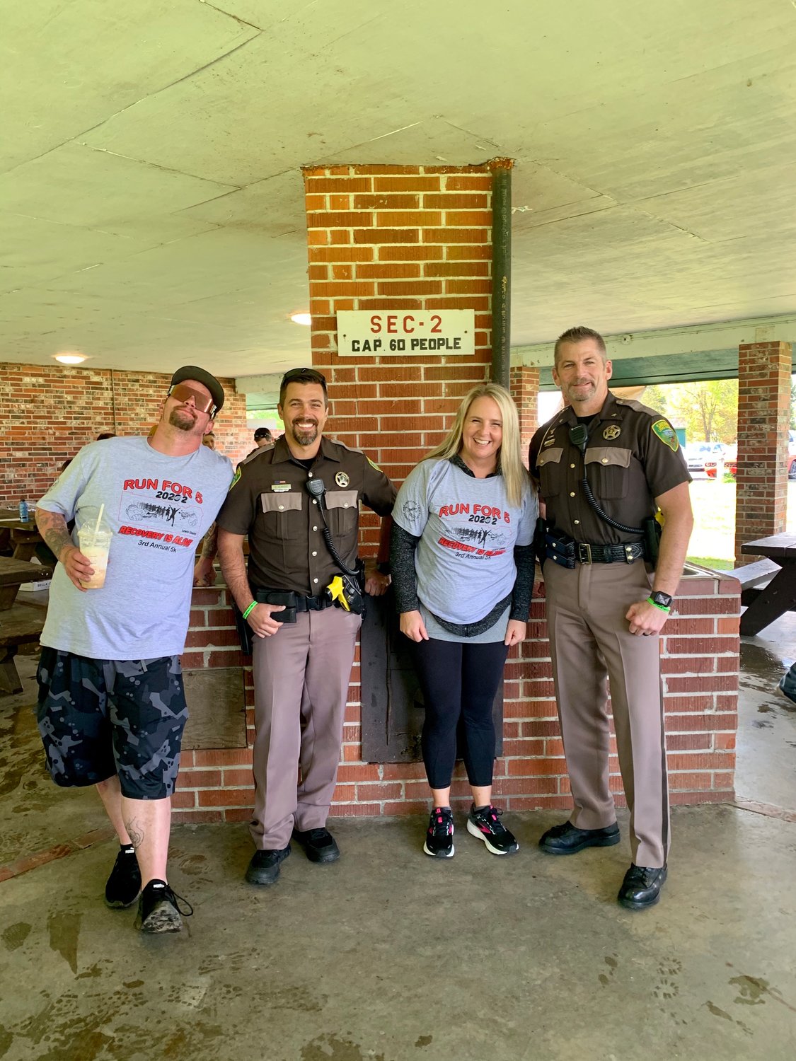 From left, Jacob Curtindale, Lewis County Sheriff’s Office Deputy Dave Albright, Becky Butler and Lewis County Sheriff’s Office Chief Chris Sweet pose for a photo at the Run for Five, Recovery is Alive 5k in Chehalis on Monday.