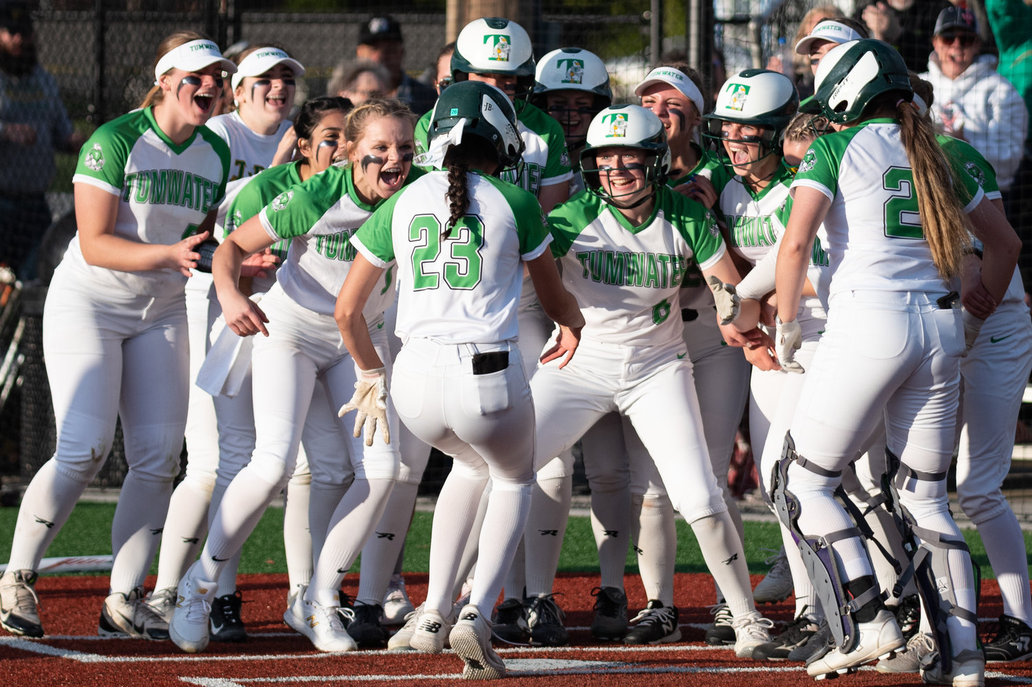 Tumwater's Jaylene Manriquez (23) is greeted by her teammates at home plate after hitting a two-run home run in the sixth inning against W.F. West in the 2A District 4 championship game at Rec Park May 20.