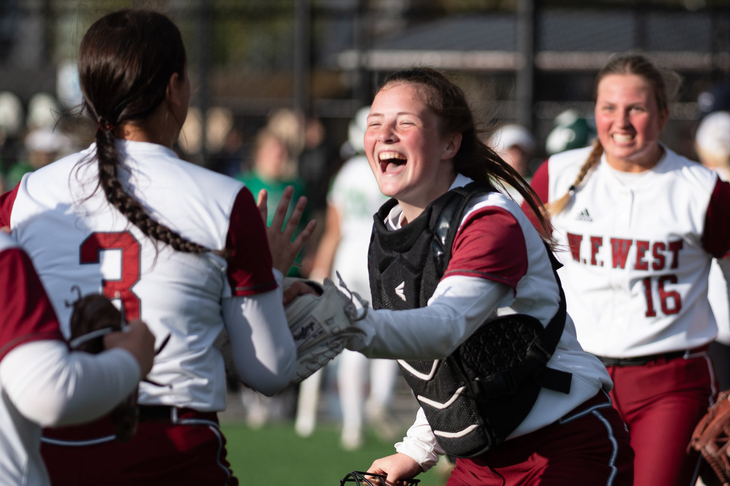 W.F. West catcher Rachel Gray finds teammate Chase White after the outfielder gunned down a runner at home plate against Tumwater in the 2A District 4 championship game at Rec Park May 20.