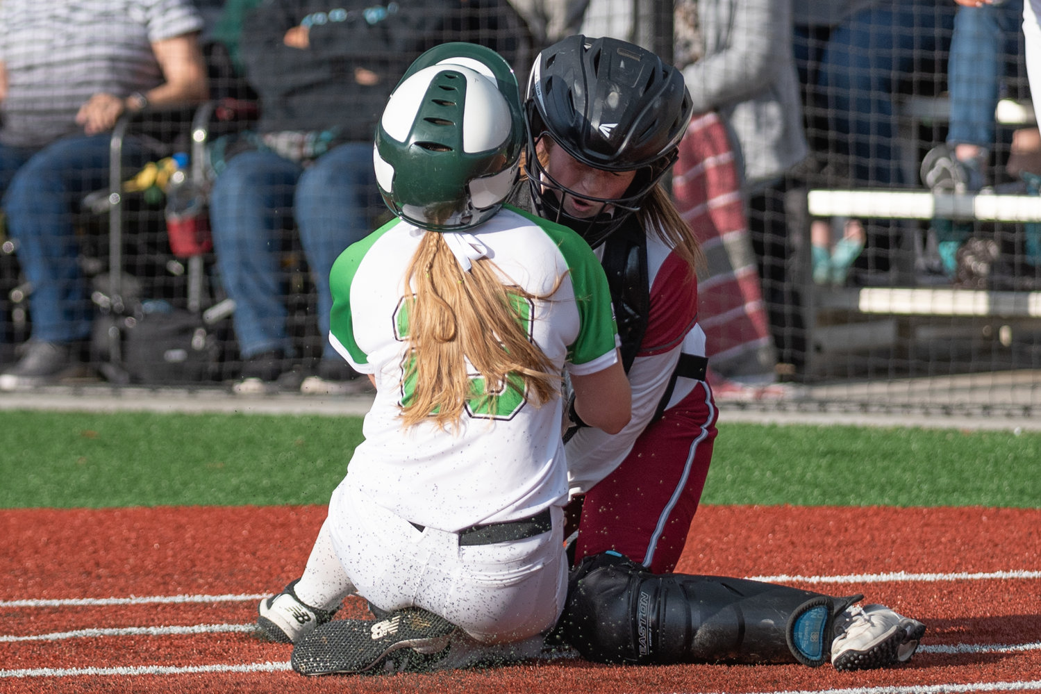 W.F. West catcher Rachel Gray holds her ground while Tumwater's Emily Robello slides into home plate in the 2A District 4 championship game at Rec Park May 20.