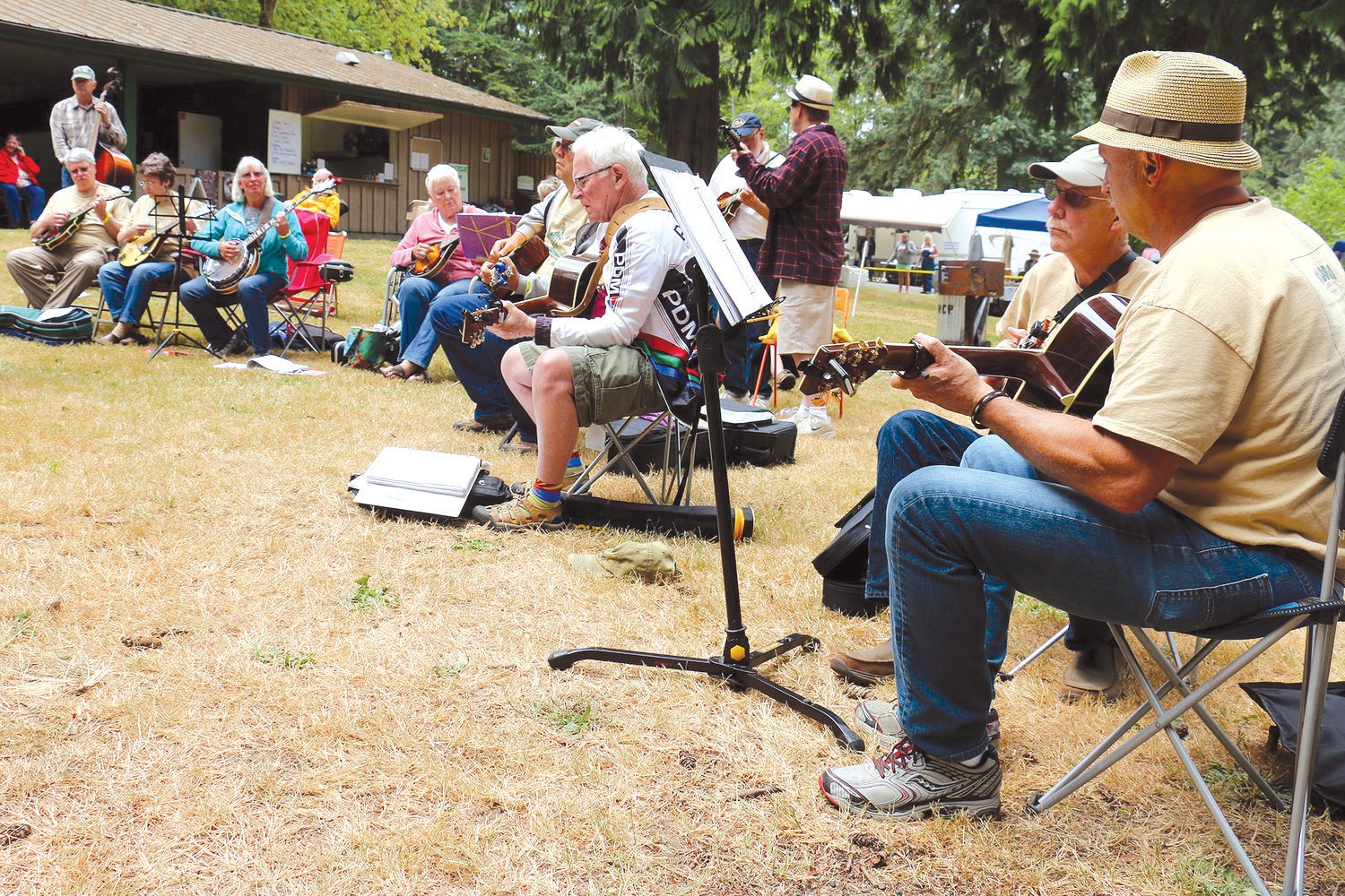 Acoustic musicians participate in a slow jam during the Winlock Pickersfest, located at Winolequa Park in July 2015.