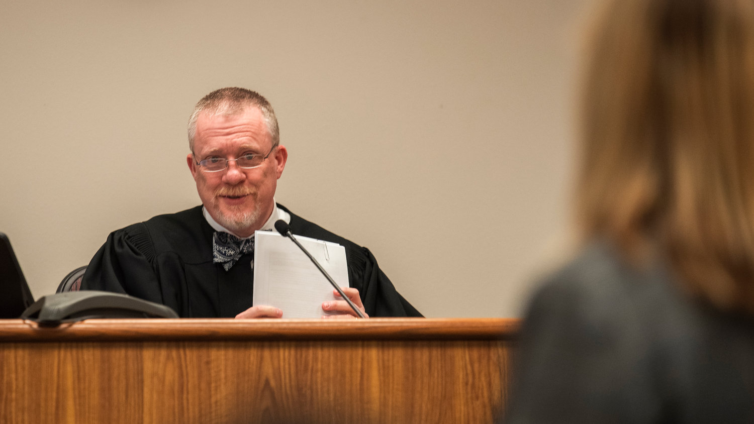 Judge Wade Samuelson talks to Laurel Khan, owner of Mackinaw's Restaurant and connected bar, Curious, in District Court Tuesday morning at the Lewis County Law and Justice Center.
