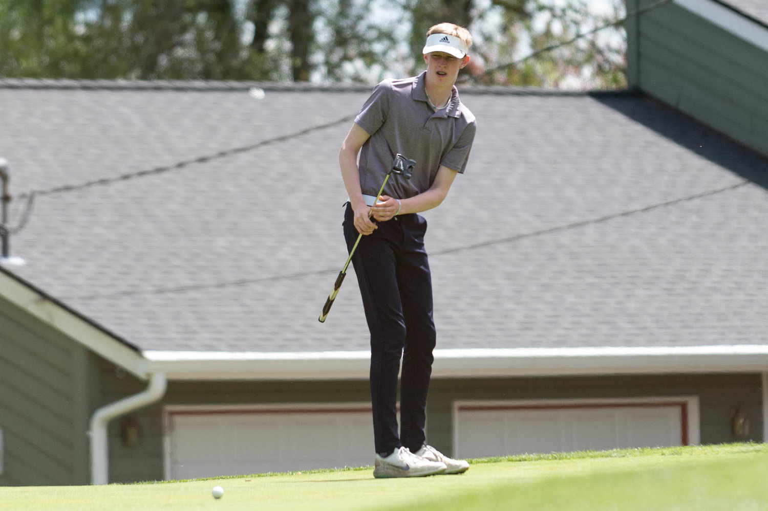 Tumwater golfer Reagan Broome watches his ball after a short put at the 2A State Golf Championships at Capital City Golf Course May 25.