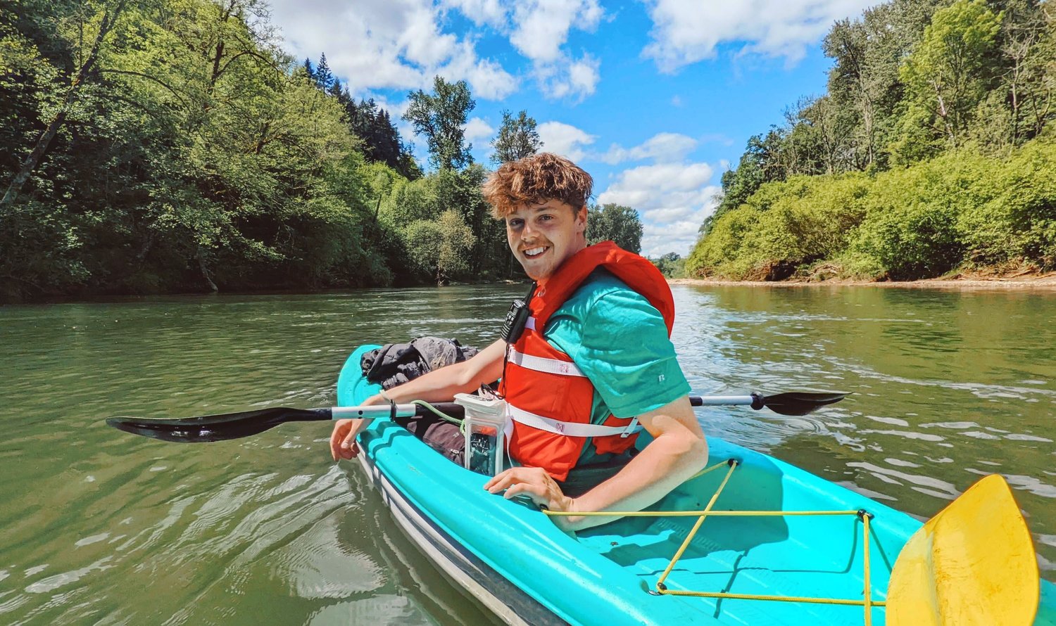 Photojournalist Jared Wenzelburger smiles and looks on from his kayak as reporter Isabel Vander Stoep snaps a photo along the Chehalis River on Wednesday.