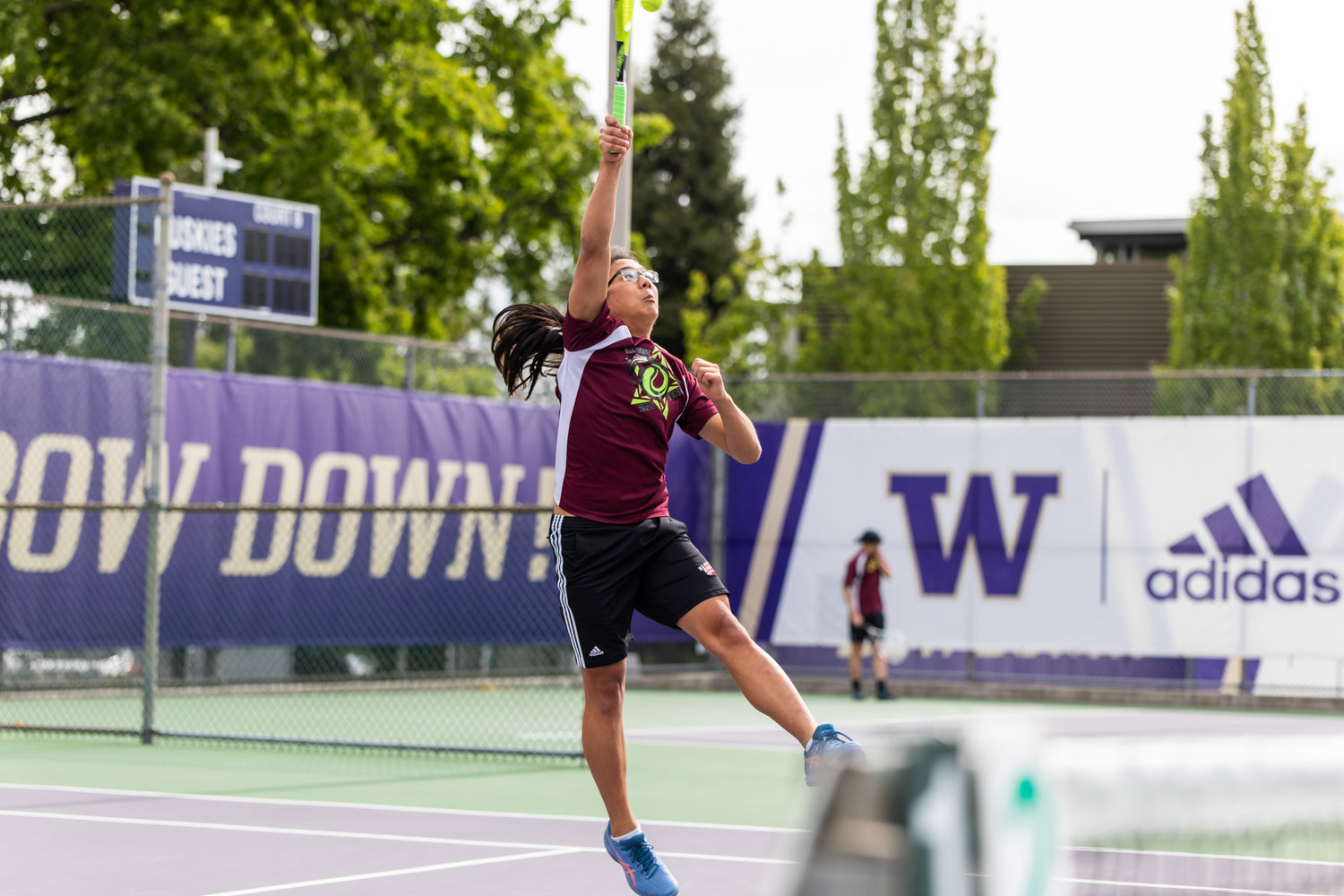 W.F. West's Joseph Chung stretches tall to reach the ball during the first set of the 2A boys' doubles tennis state competition on May 27, 2022.