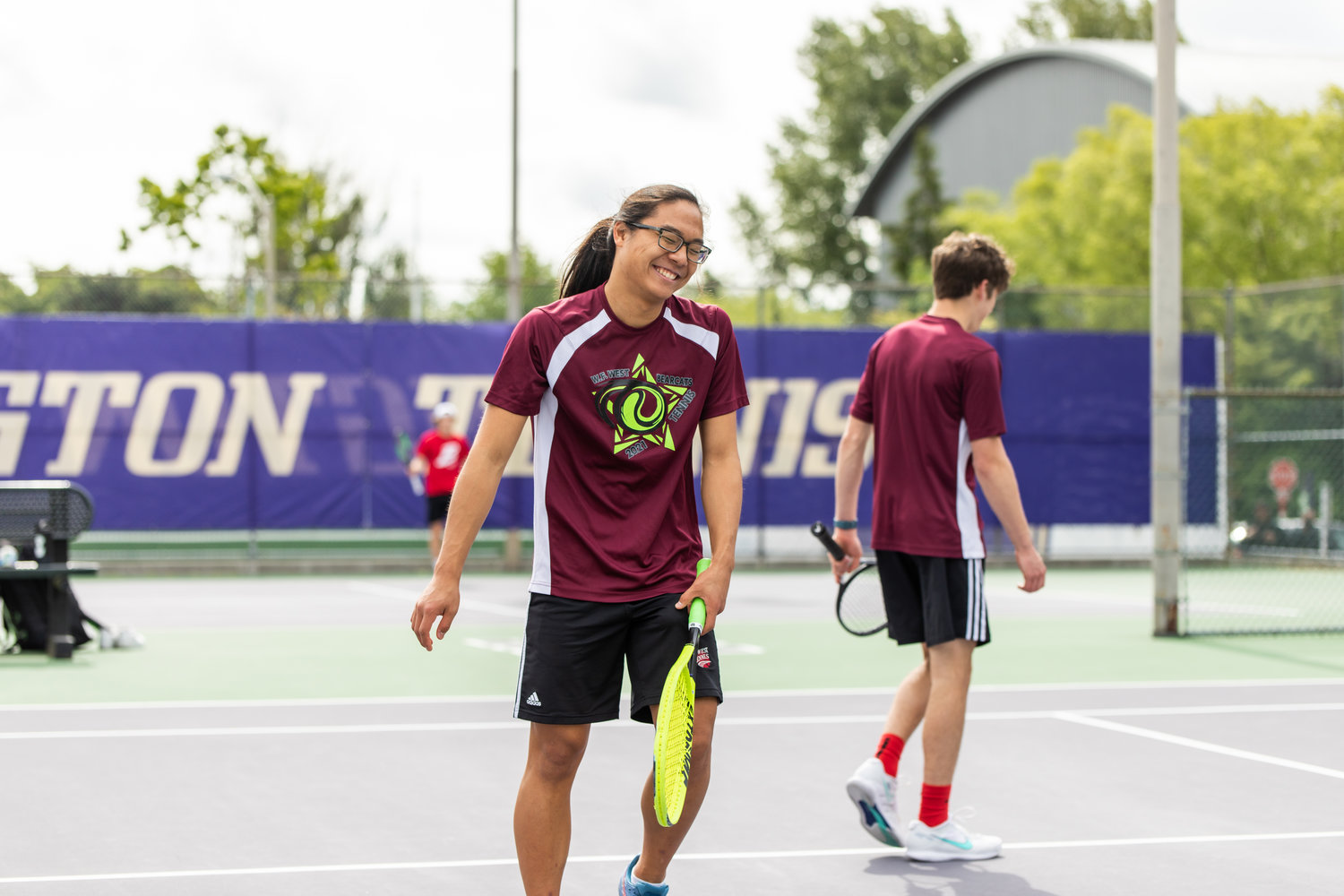 W.F. West's Joseph Chung laughs during the first set of the 2A boys' doubles tennis state competition on May 27, 2022.