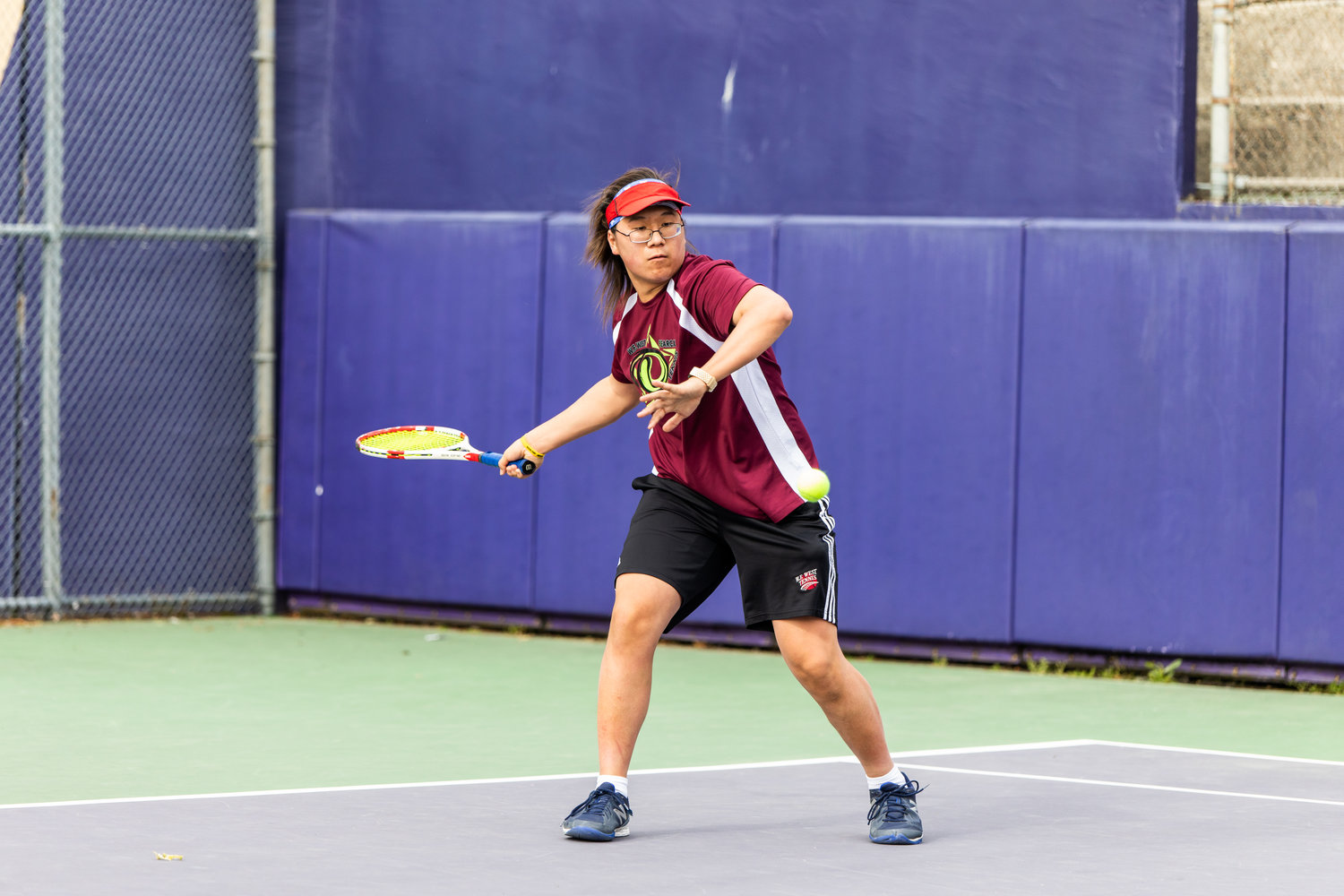 W.F. West's Justin Chung eyes the ball during the first set of the 2A boys' singles tennis state competition on May 27, 2022.