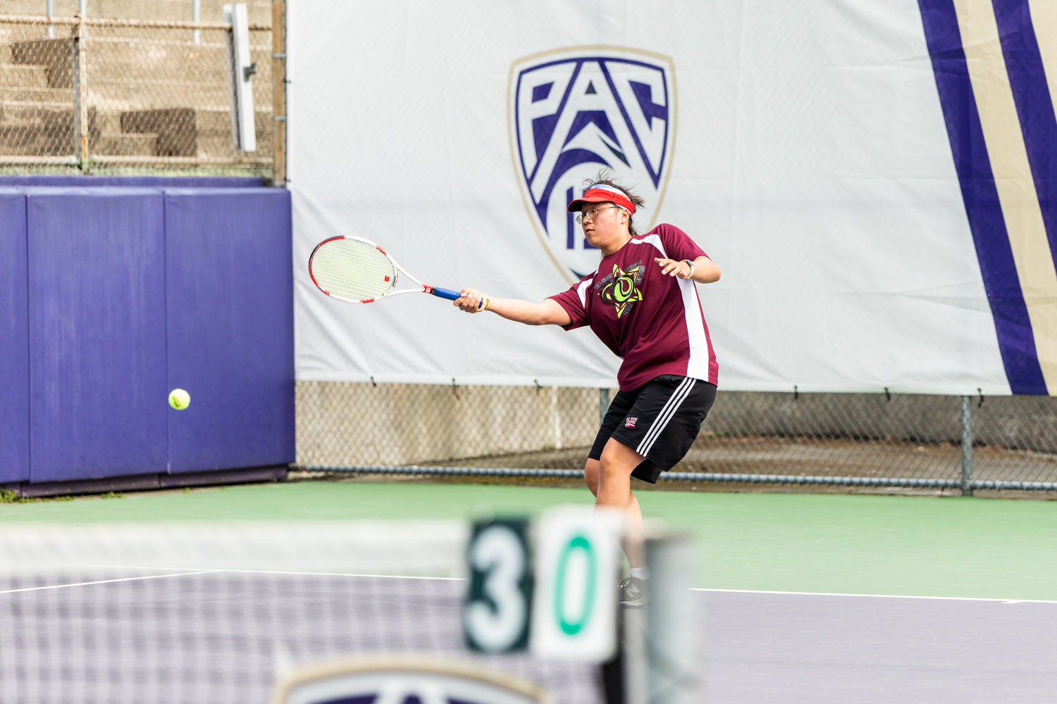 W.F. West's Justin Chung watches his hit during the first set of the 2A boys' singles tennis state competition on May 27, 2022.