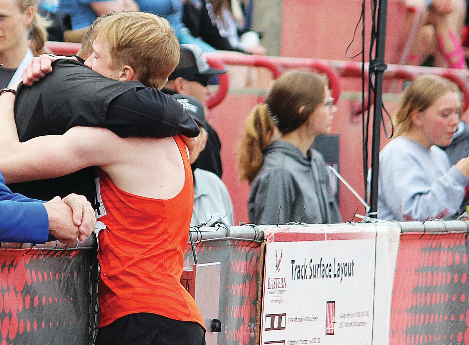 Napavine's Lucas Dahl gets a hug after winning the State 2B 200-meter dash, his second state title at the State 1B/2B/1A Track and Field Championships in Cheney, Wash.