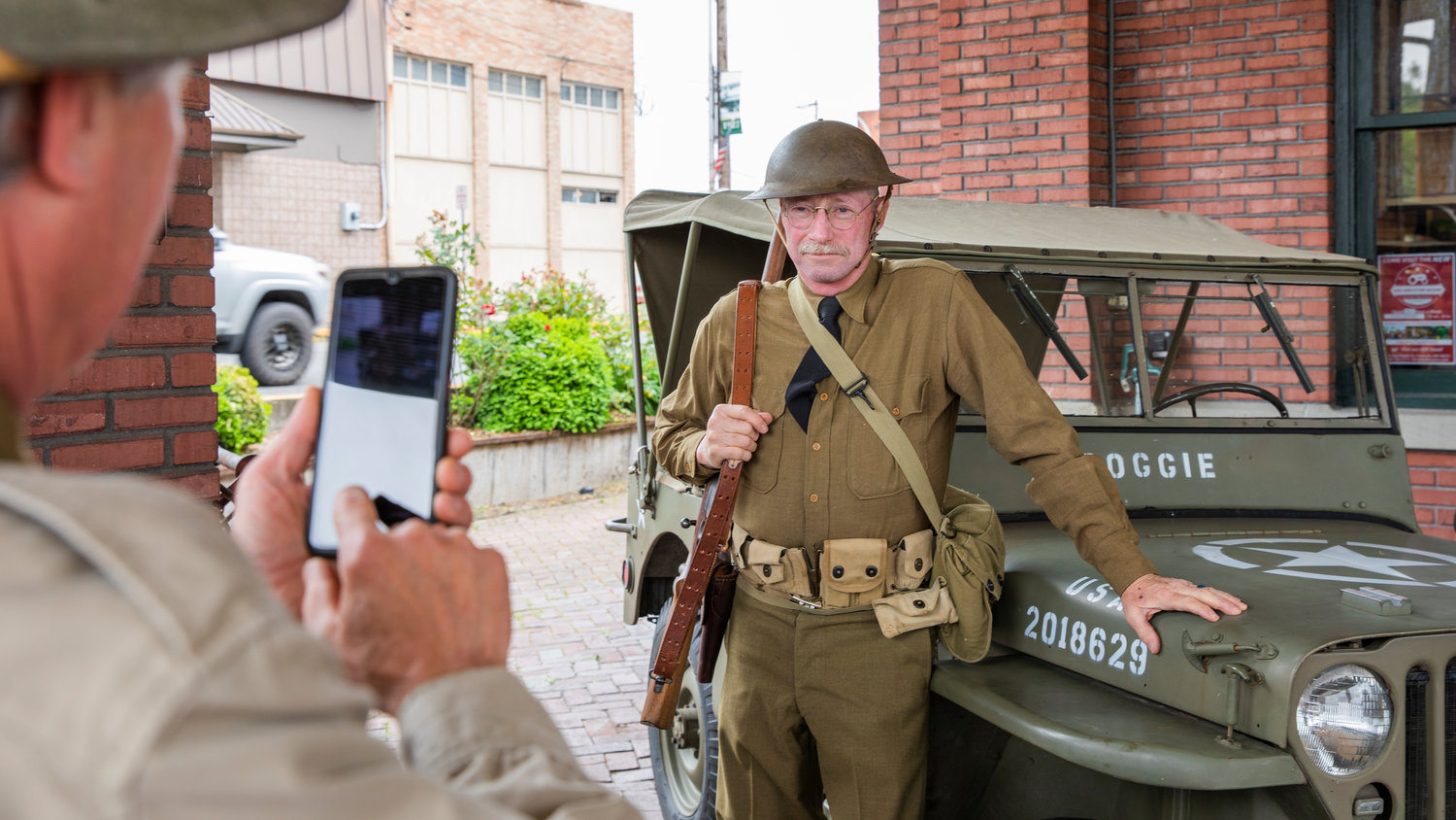 Scott Harriage takes a picture of Lawrence Sandlin wearing an early WWII outfit at the Lewis County Historical Museum in Chehalis.