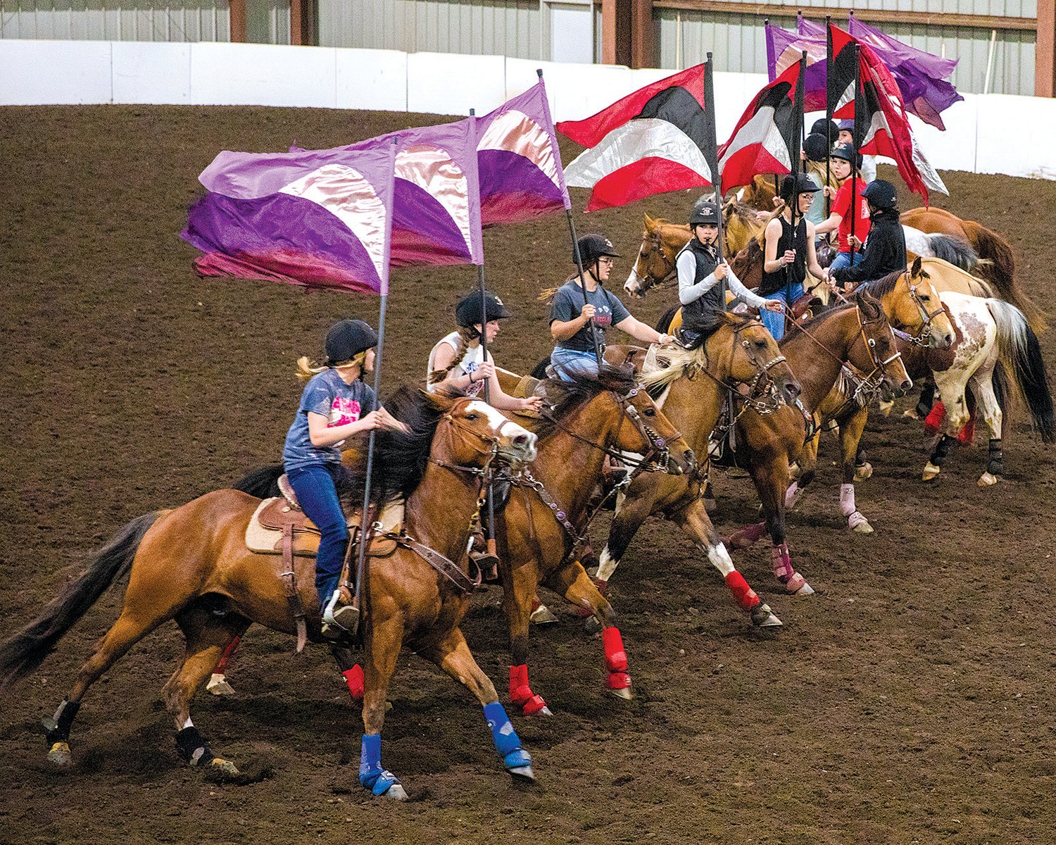 The W.F. West equestrian drill team runs through choreographed movements to music in Salkum’s Rocky Top Arena on Monday.