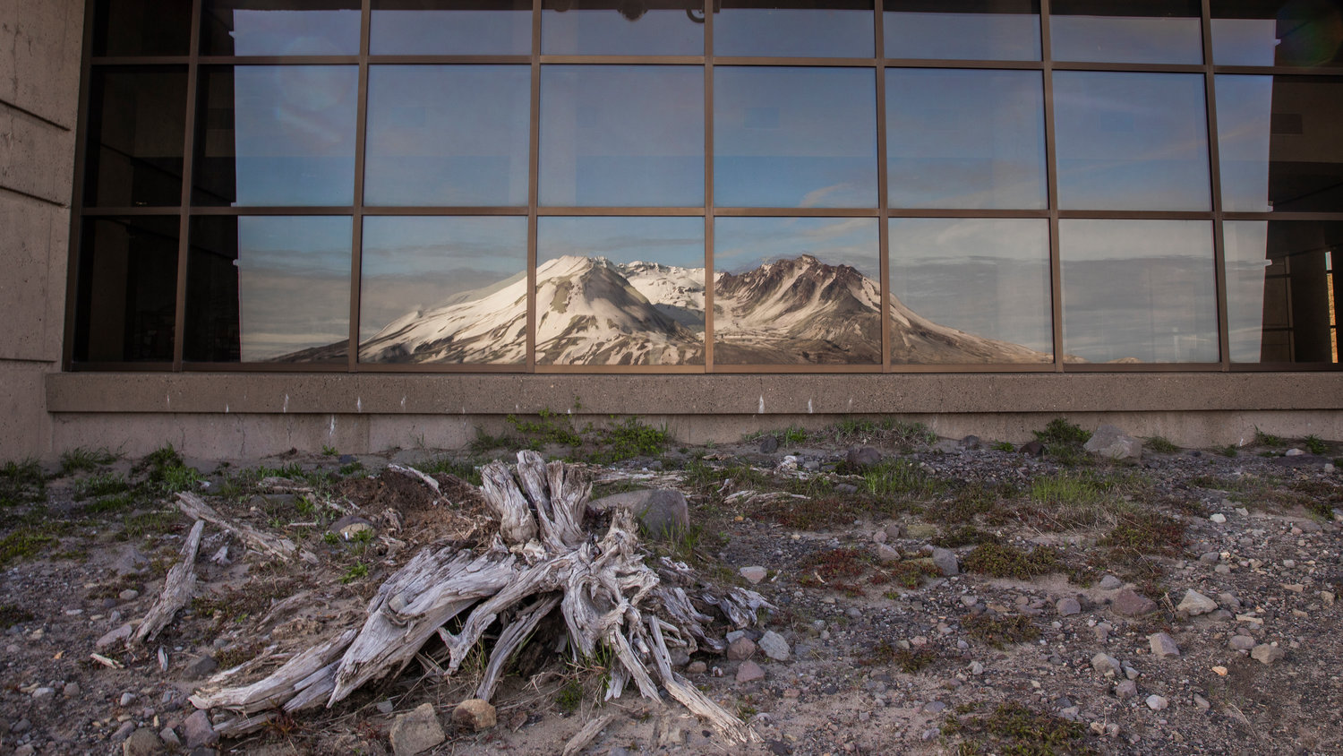 Mount St. Helens is seen in the reflection of windows on the Johnston Ridge Observatory on Wednesday.
