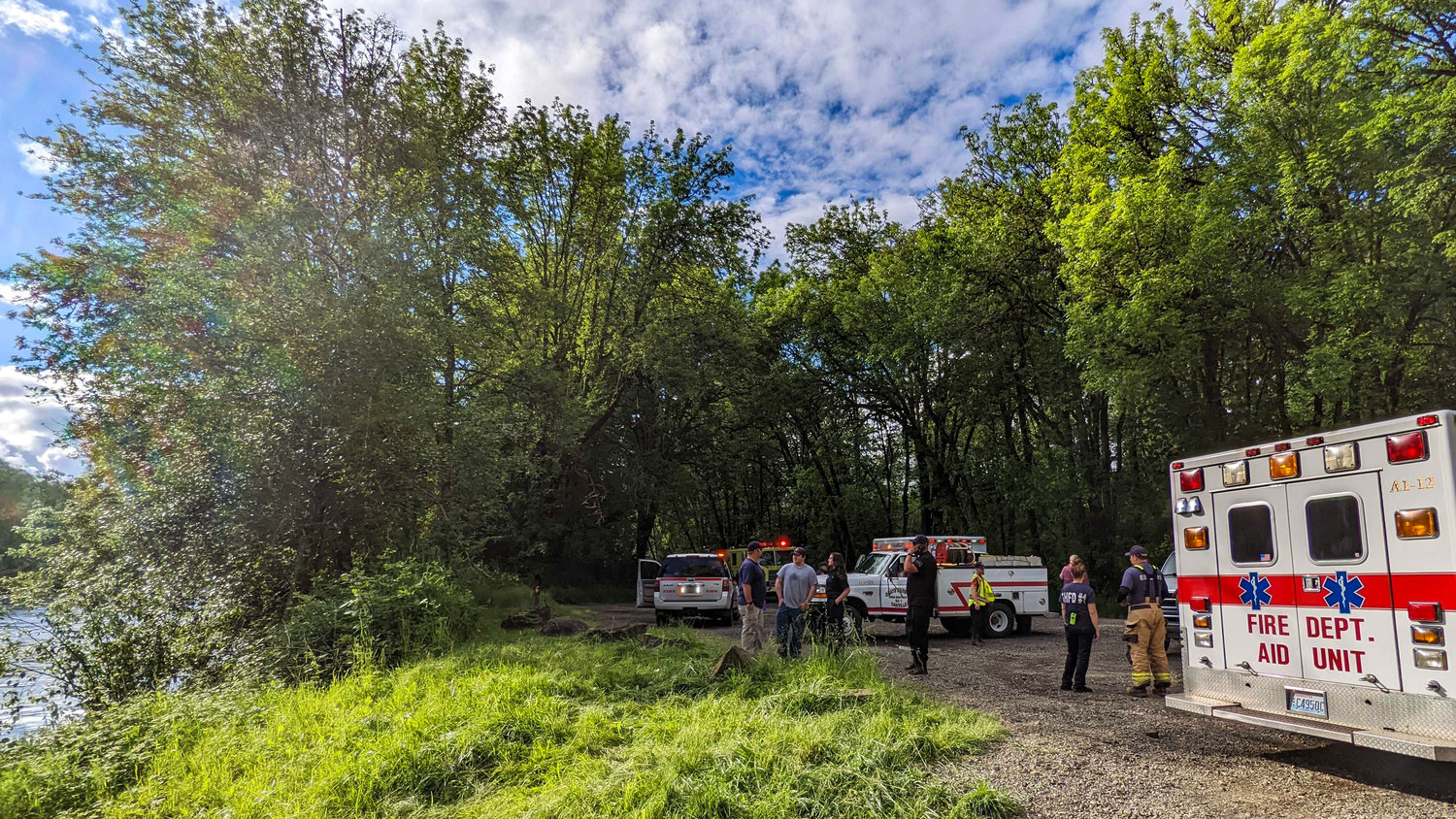 Responders including Grays Harbor Fire District 1 and the Grays Harbor Sheriff's Office stand on the scene after rescuing a man from the Chehalis River on Saturday.