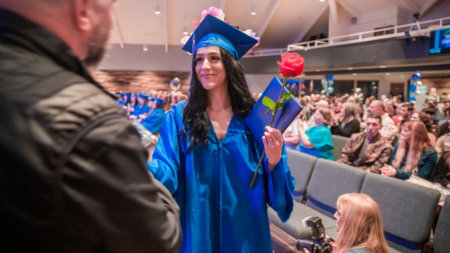 Maddix Rain Lopez smiles as she receives a flower and her diploma during a graduation ceremony for Futurus High School in Centralia Tuesday evening.