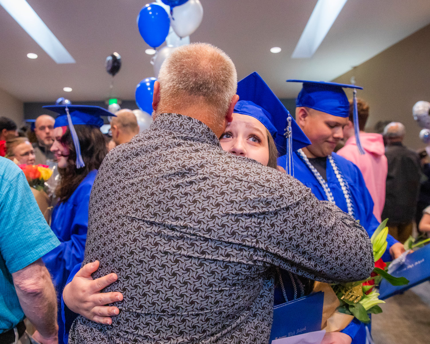 Graduates from Futurus High School are greeted by family following a ceremony in Centralia Tuesday evening.