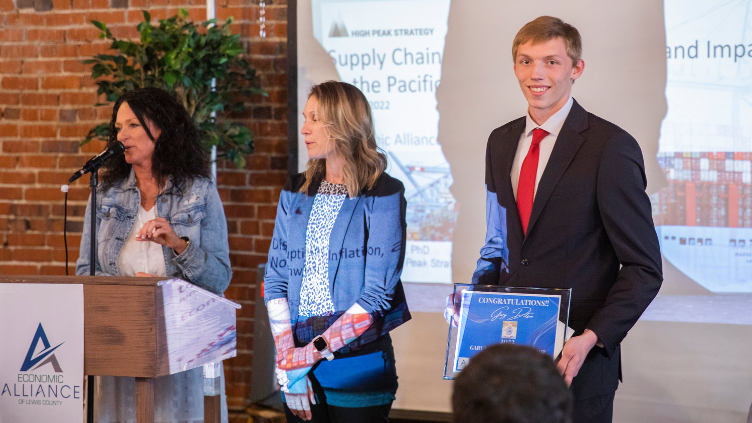 Gary Dotson, the Gary Stamper Scholarship recipient, smiles for a photo while standing to be recognized at The Loft during an Economic Alliance Summit event in Chehalis on Thursday.