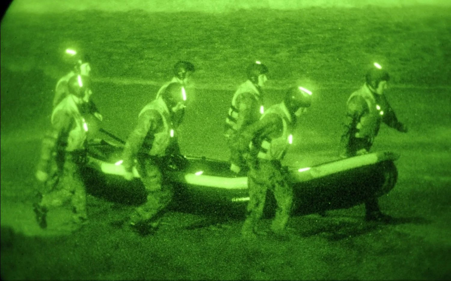 Students from Basic Underwater Demolition/SEAL class 281 carry an inflatable boat toward the surf during a first phase navigation training exercise in San Diego in February 2010.