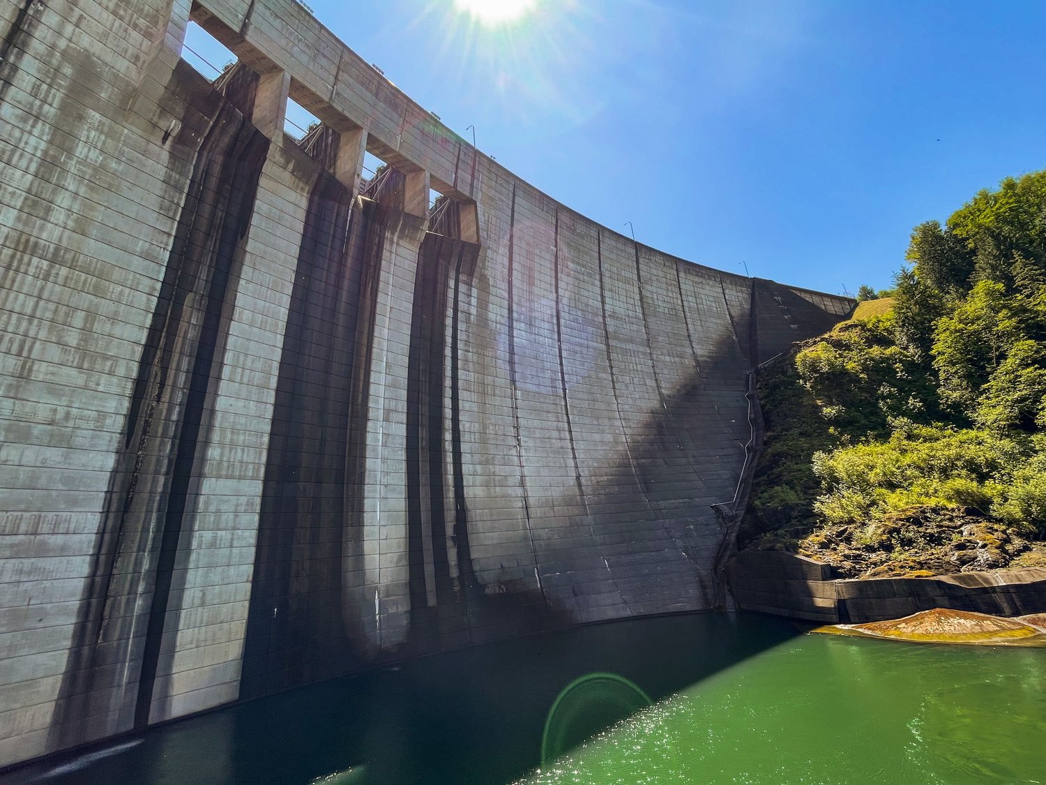 The sun shines down on the Mossyrock Dam casting a shadow on the water Tuesday.