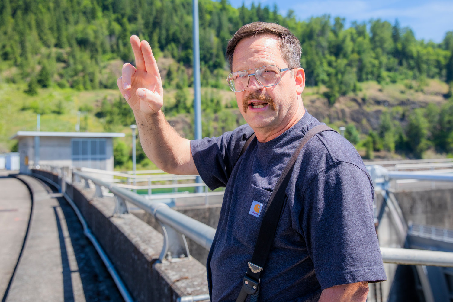 Journeyman Clarence Lupo talks about electricity flowing through cables around the dam near the Tacoma City Light powerhouse Tuesday in Mossyrock.