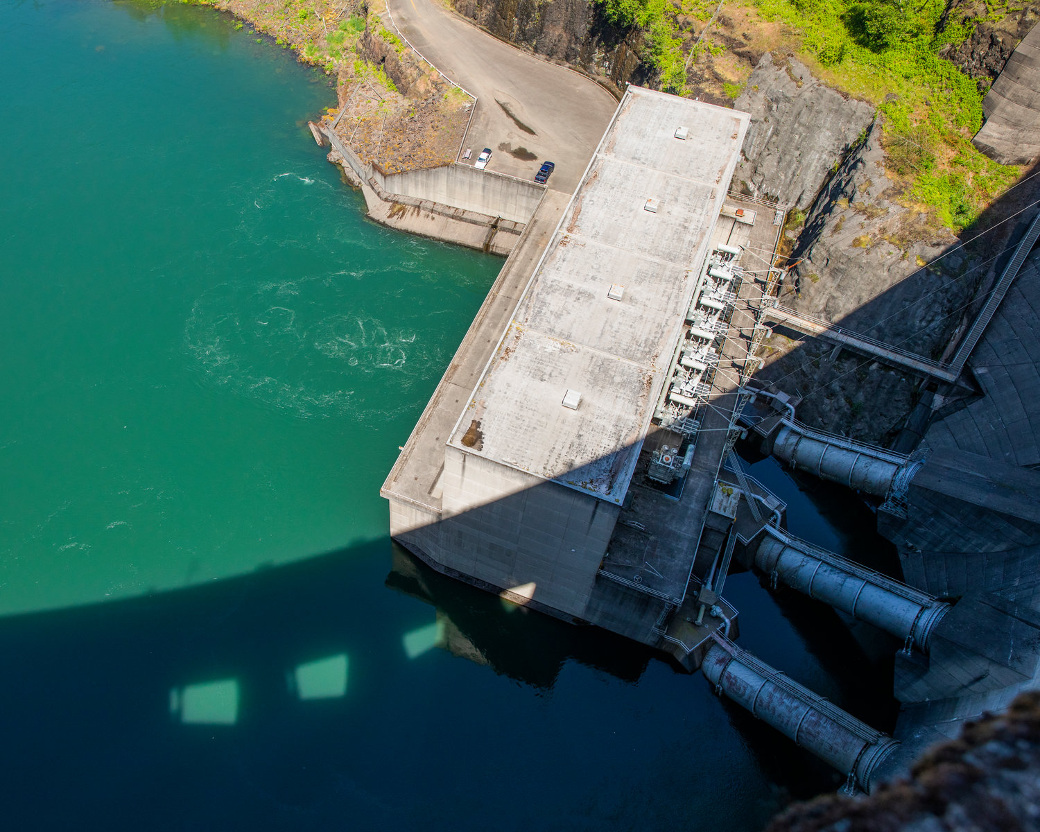 The Mossyrock Dam casts a shadow on the Tacoma City Light powerhouse Tuesday morning.