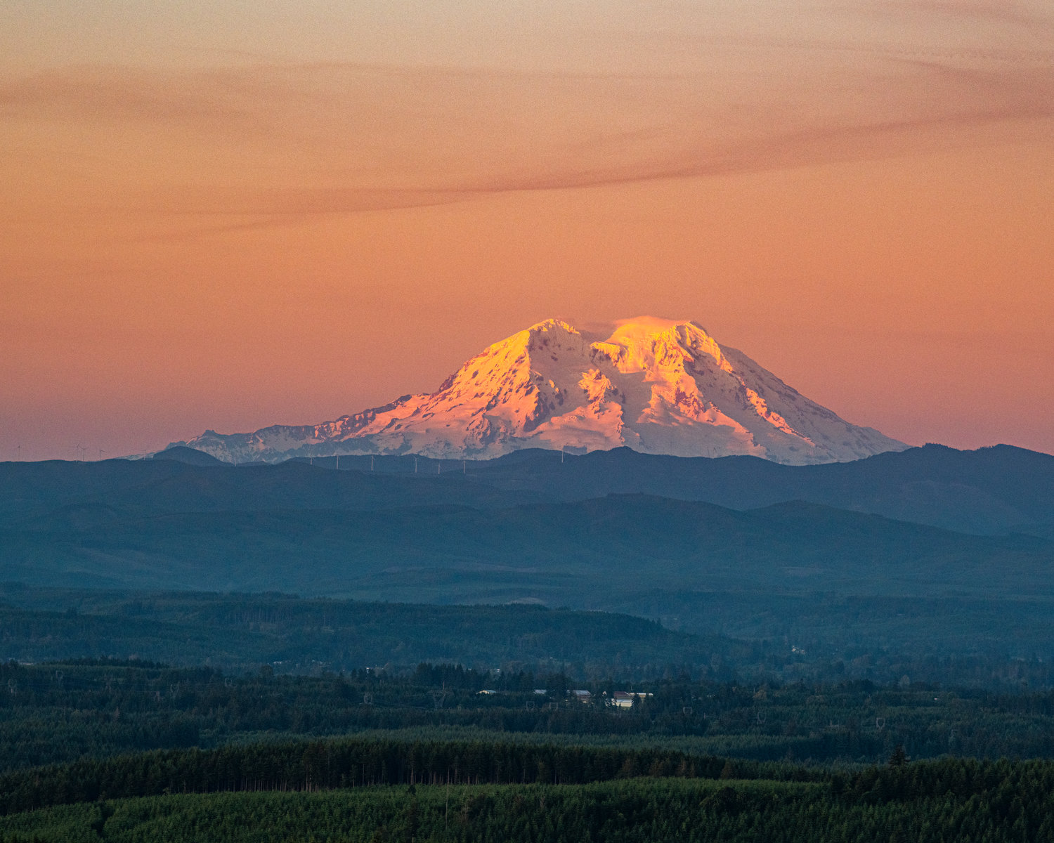 The top of Mount Rainier glows organge during the sunset, pictured from Crego Hill in Adna on Tuesday evening.