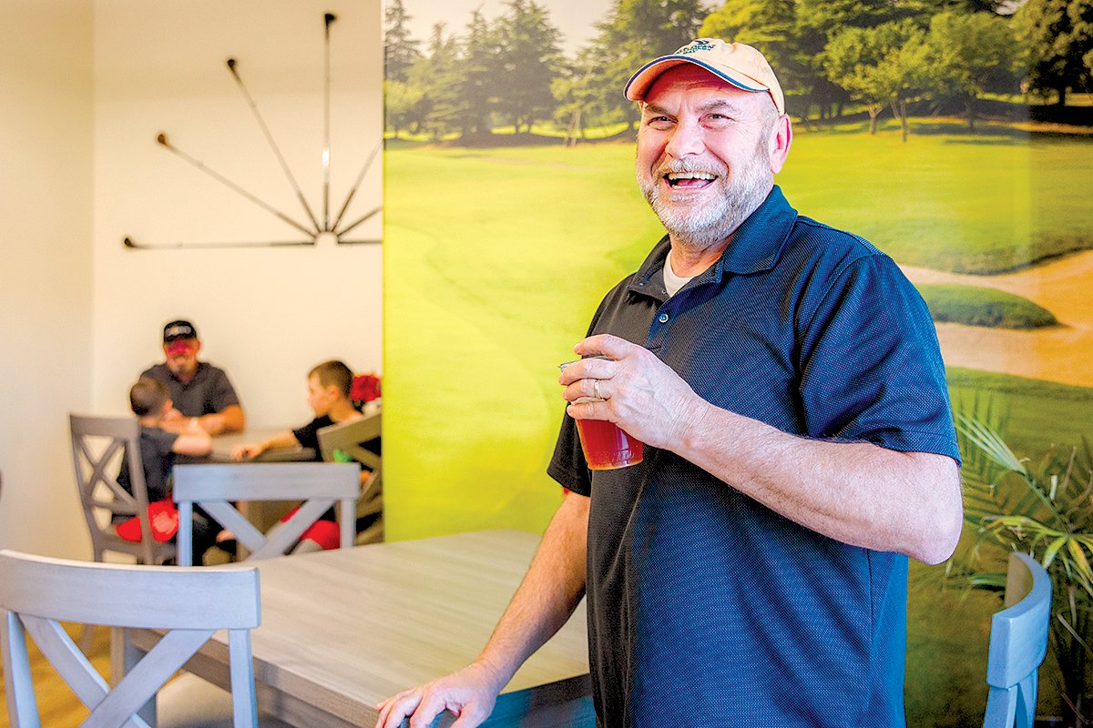 Todd Chaput enjoys a beverage at Par 4 Sports in Centralia on Thursday during a grand opening event.
